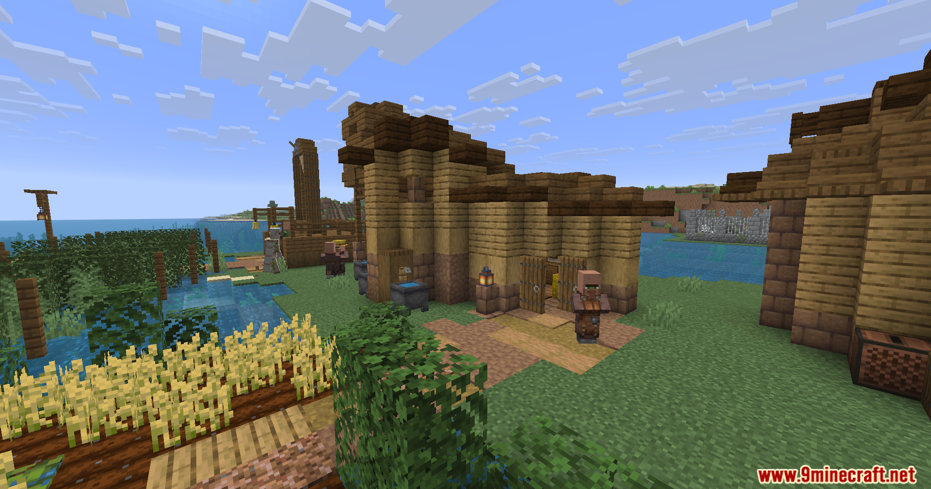 Epic Structures Villages Mod Screenshot 8 A sprawling medieval settlement with wheat farms and houses near the coast