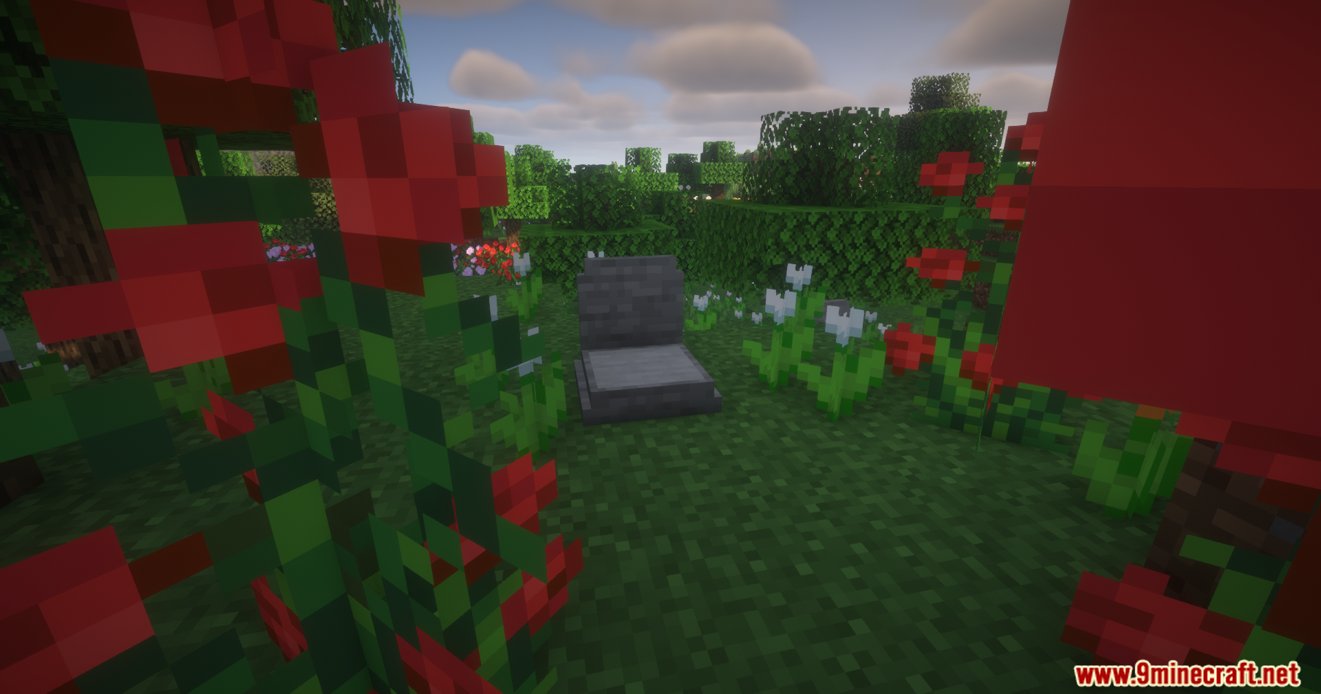 Epitaphs Mod Screenshot 3 A stone grave surrounded by red and white flowers in a Minecraft garden
