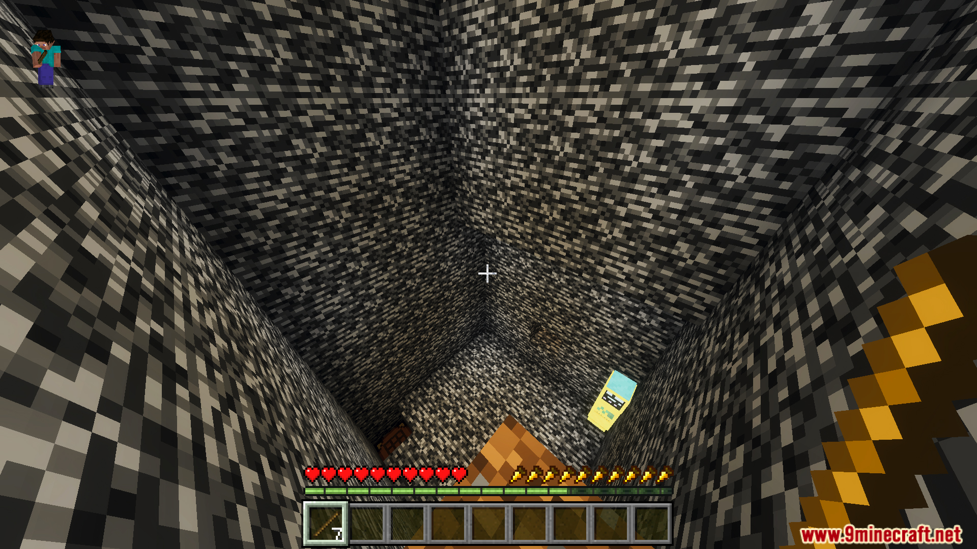 Player looking down a deep bedrock shaft towards a yellow character below