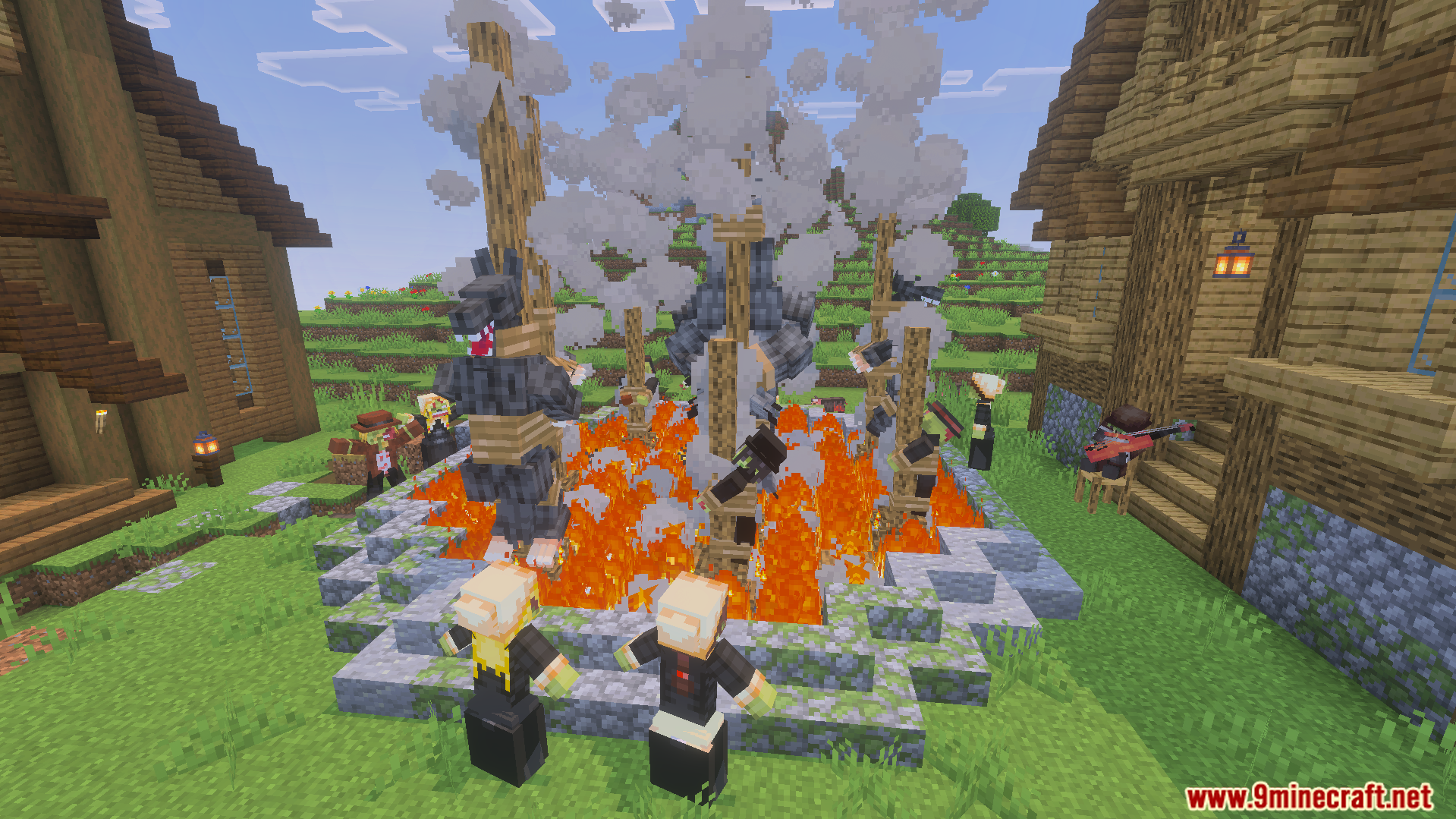 Scary werewolves tied to wooden stakes around a large campfire in a village