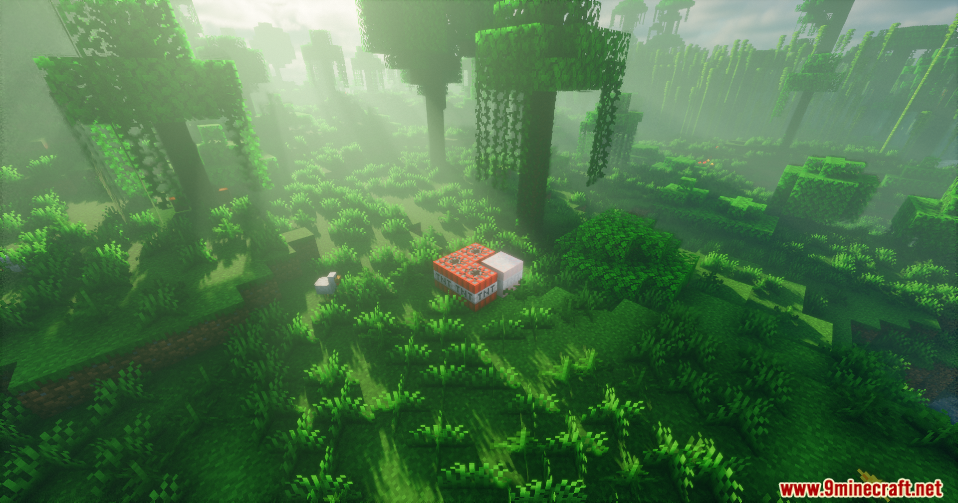 Explosion Overhaul a New Level of Destruction Mod Screenshot 14 Several TNT blocks placed on the grass in a foggy jungle environment