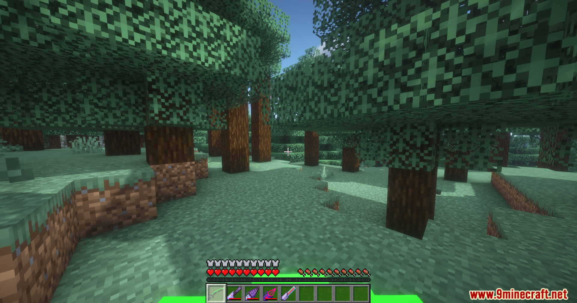 Extended Industrialization Mod Screenshot 12 Player holding advanced industrial tools in a forest with a green energy bar