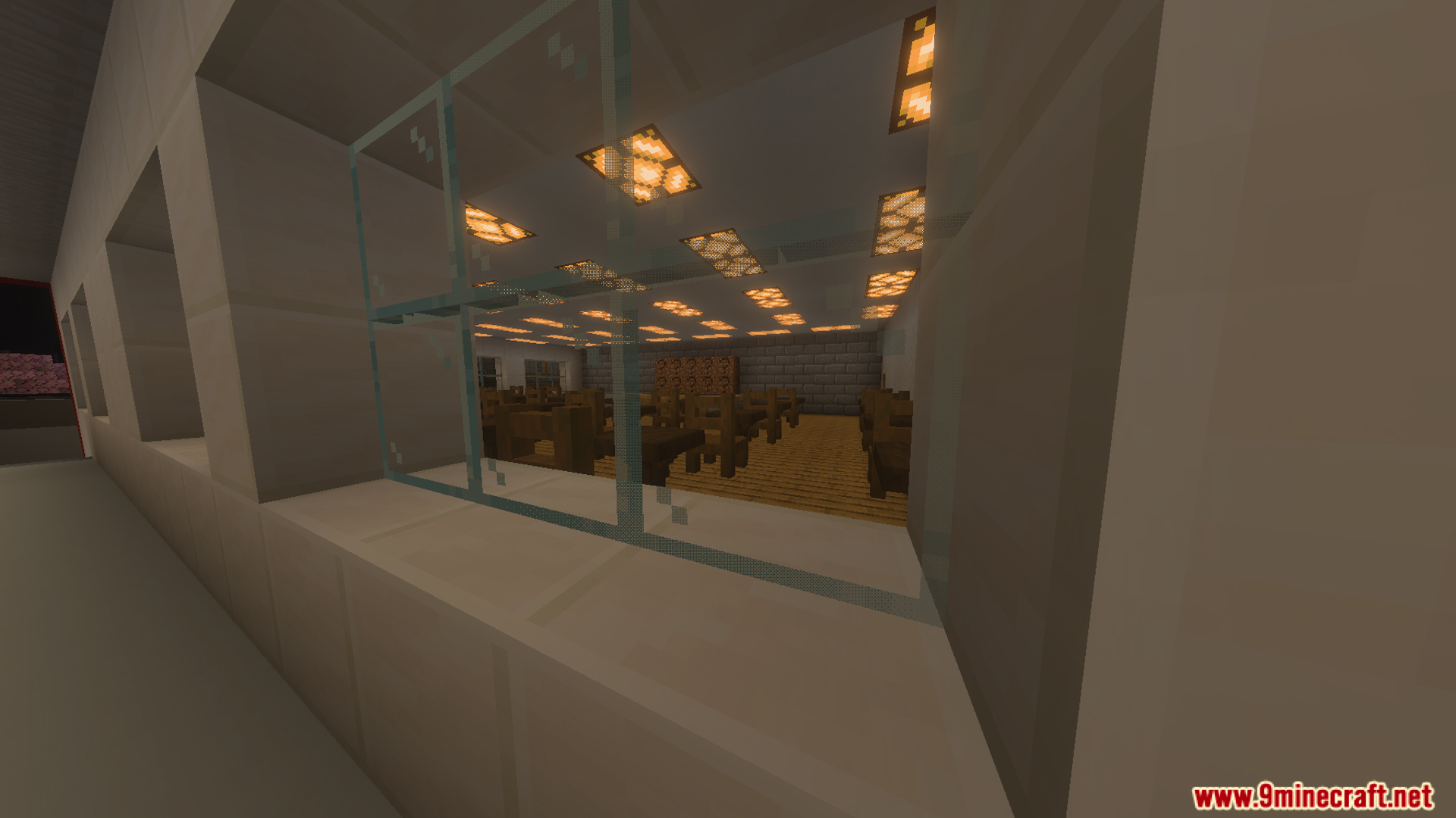 Looking through a glass window into a dining area with many tables