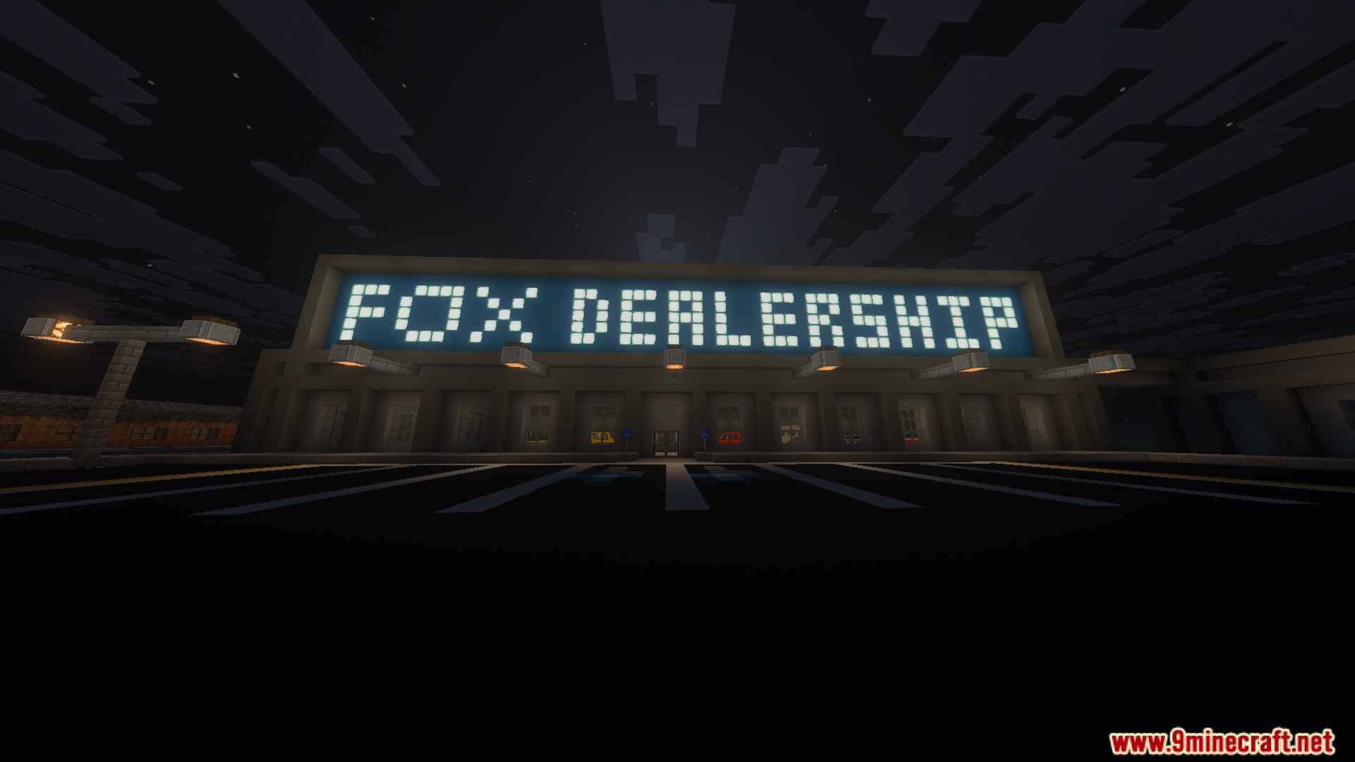 The Fox Dealership building with a bright glowing sign at night