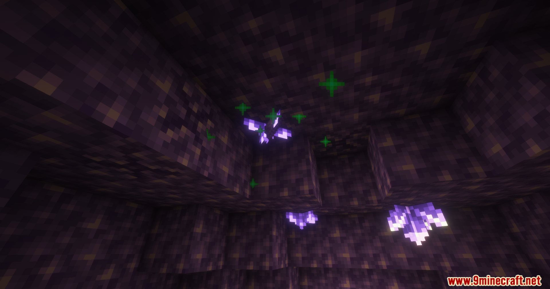 Amethyst crystals hanging from the ceiling with green particles showing growth stages