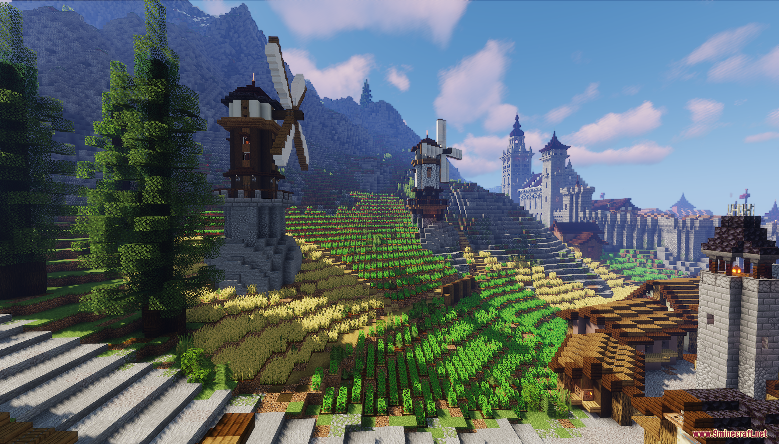 Windmills stand beside terraced fields of crops in a beautiful fantasy landscape