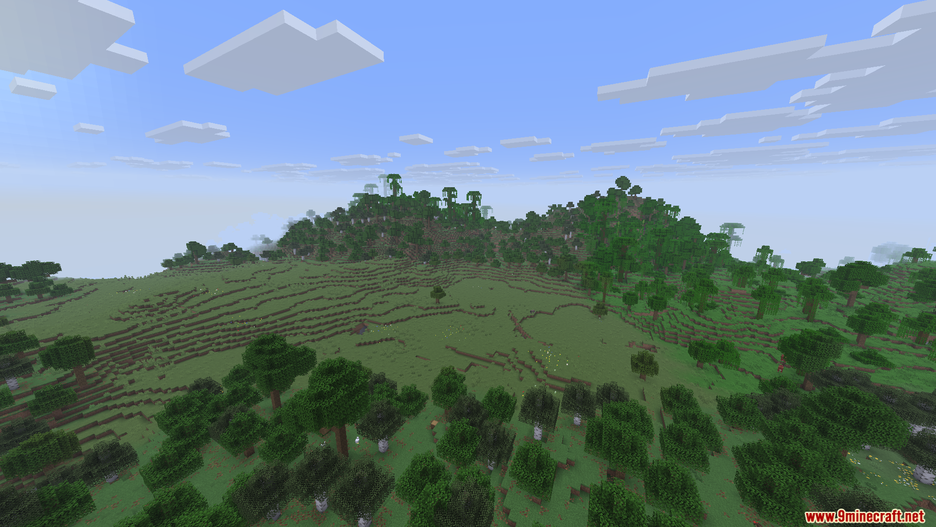 Fast Server Pings Mod Screenshot 6 Rolling green hills and open plains surrounded by a lush forest landscape