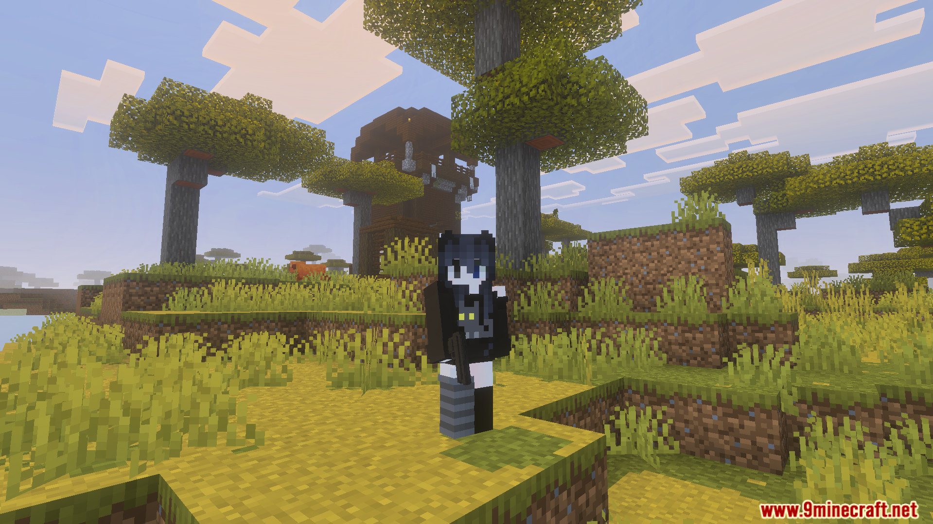 Player character holding a black pistol with a pillager outpost in the distance