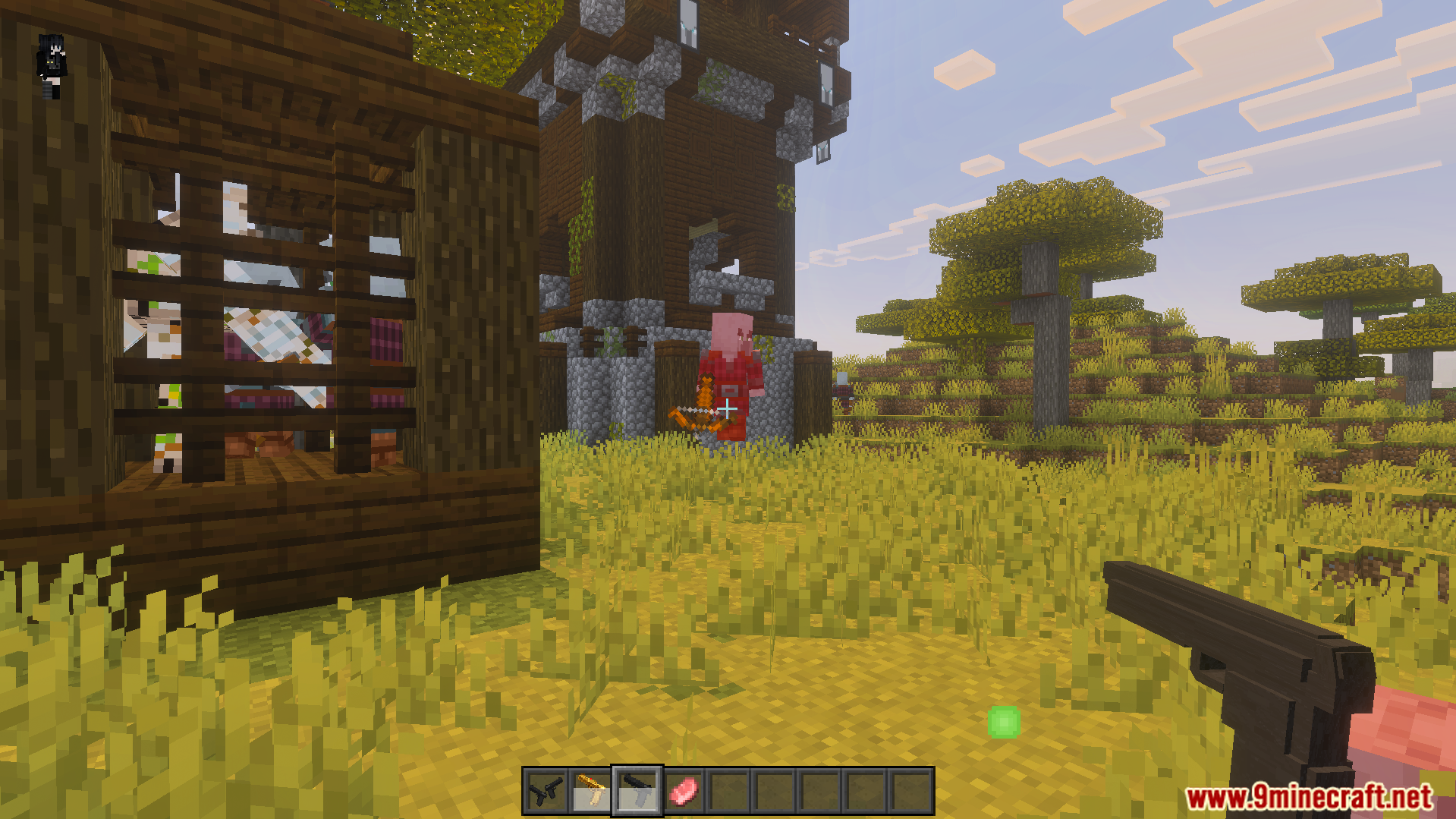 Player holding a 3D pistol near a pillager outpost and iron golem