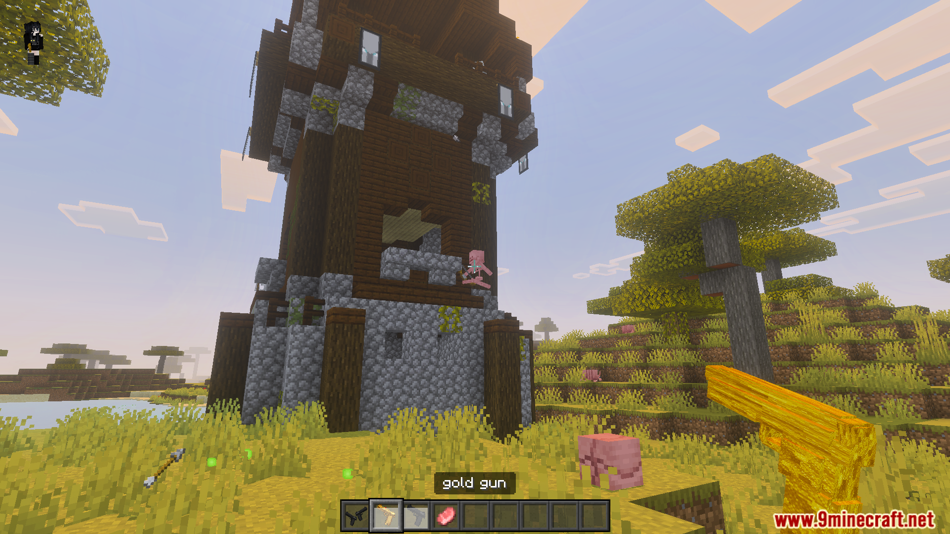 Ferous Gun Addon showing player holding gold gun near a tower
