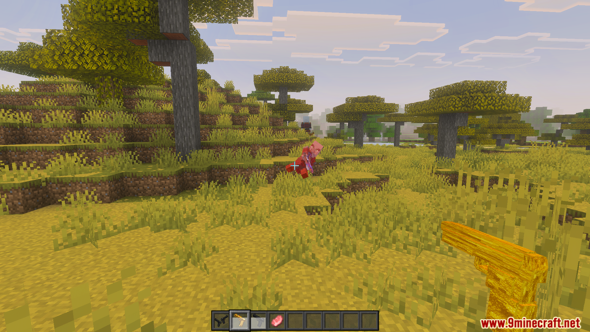 Player aiming a gold gun at a mob in a savanna biome