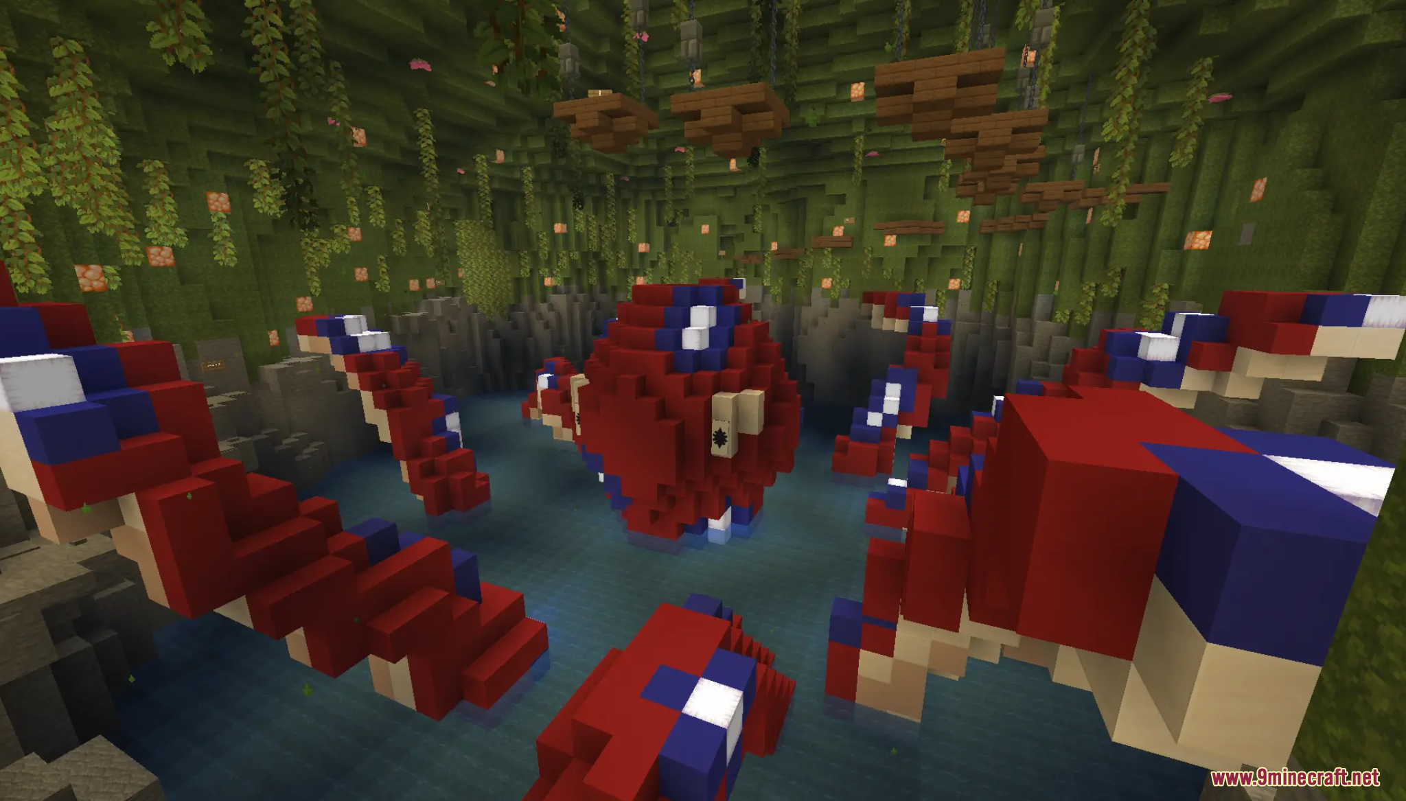 A giant red heart shaped creature surrounded by tentacles in a lush cave