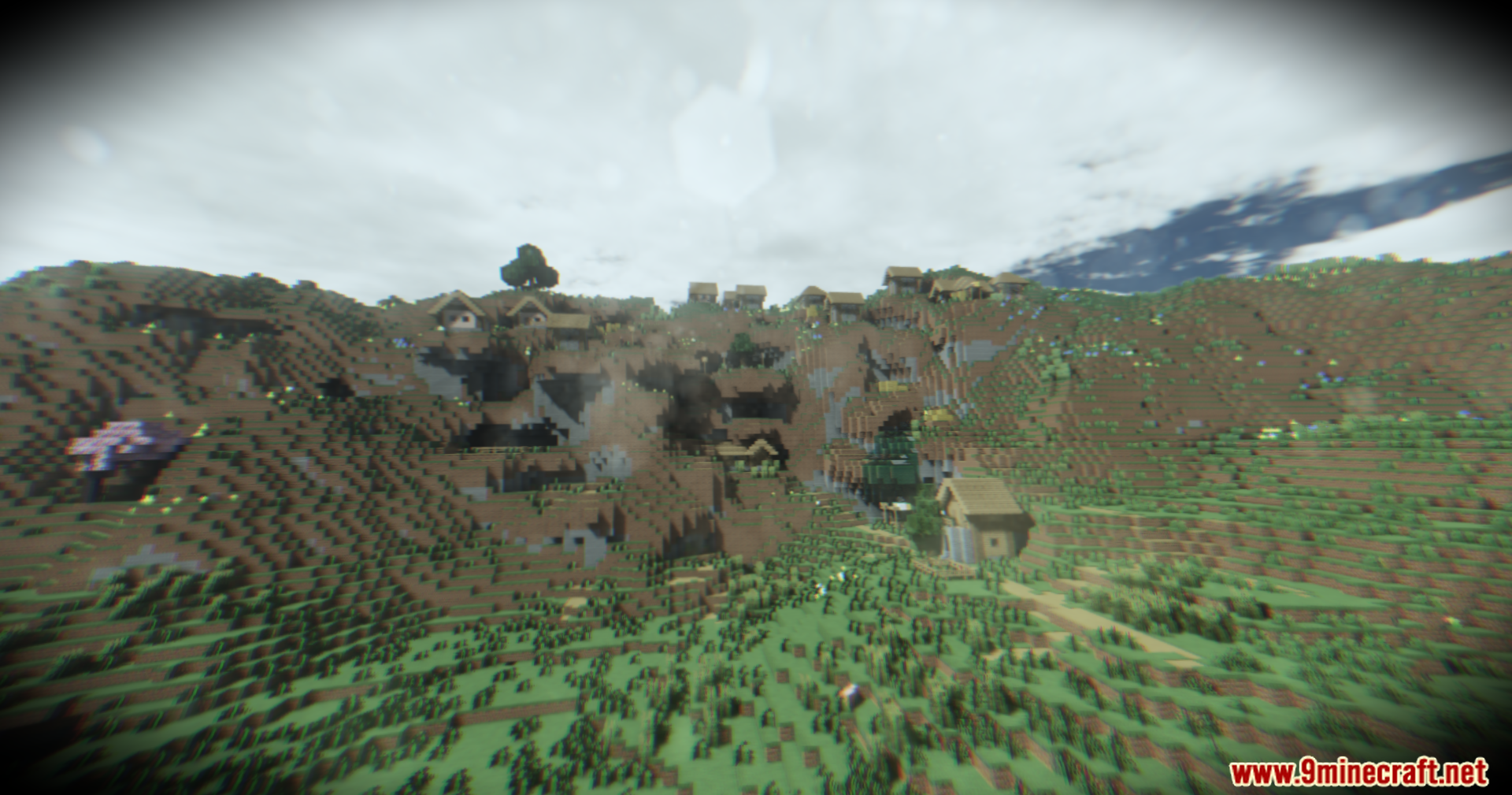 Footage Shaders Screenshot 10 Hillside village in Minecraft displayed with gritty VHS style video effects