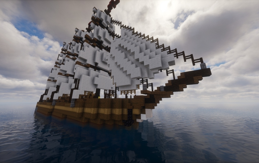 A large wooden sailing ship with white sails floating on the ocean