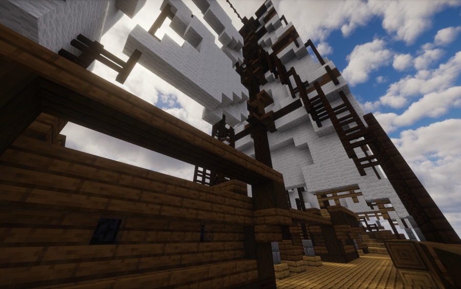 A view from the deck of a large wooden ship with tall masts