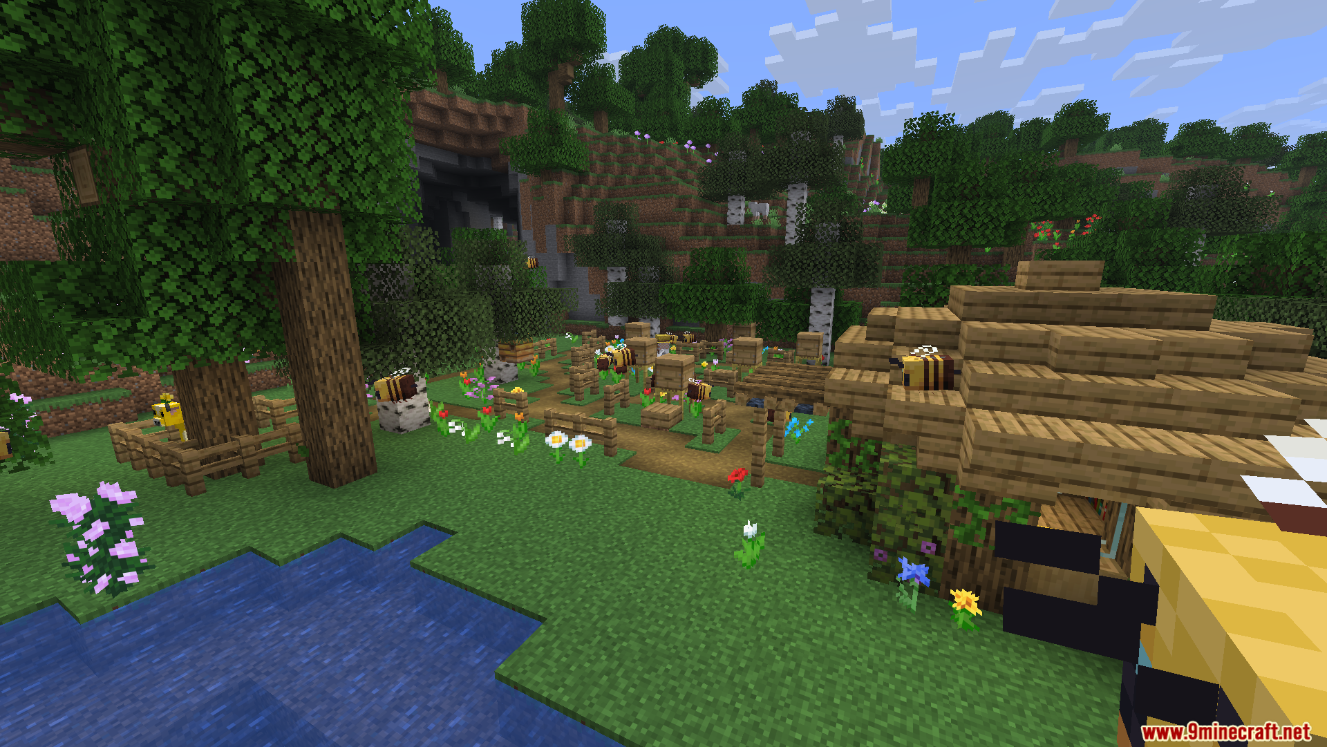 Friends N Foes Beekeeper Hut Mod Screenshot 3 A wooden beekeeper hut surrounded by flowers and bees in a meadow biome