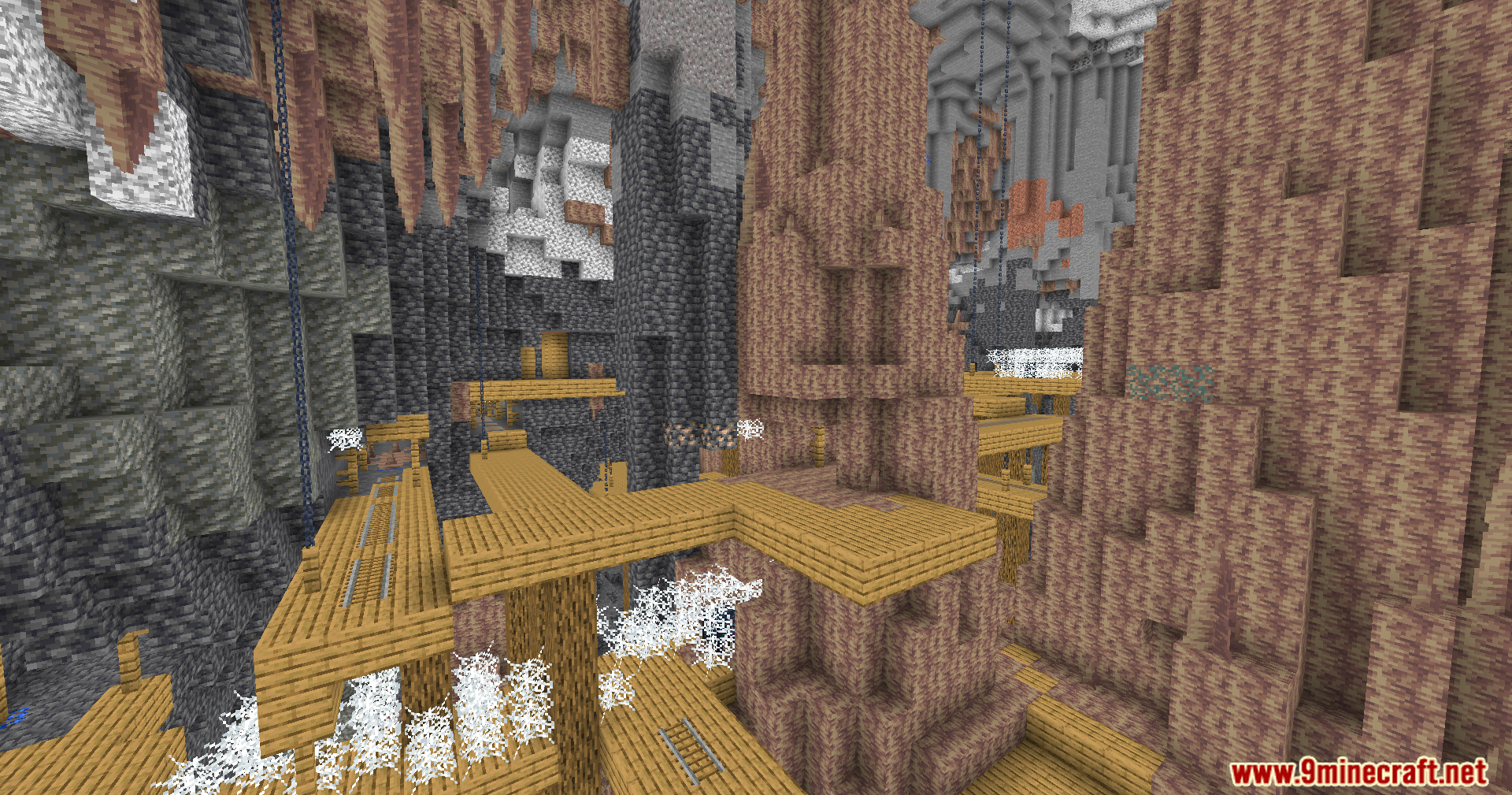 Bright underground mineshaft with wooden bridges and dripstone formations in a large cave