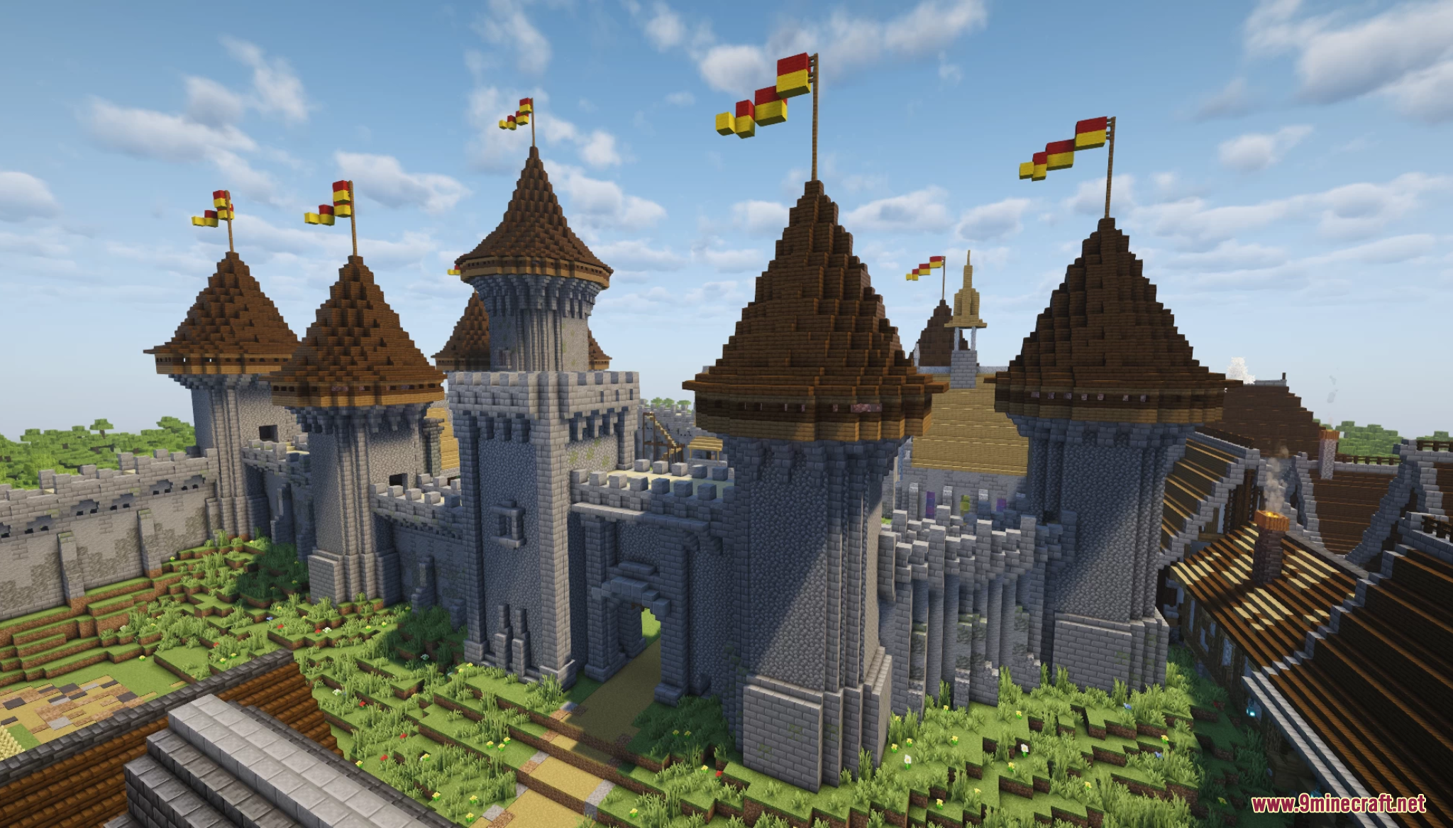 A large stone castle with multiple towers and flags in Gallardon Medieval Village