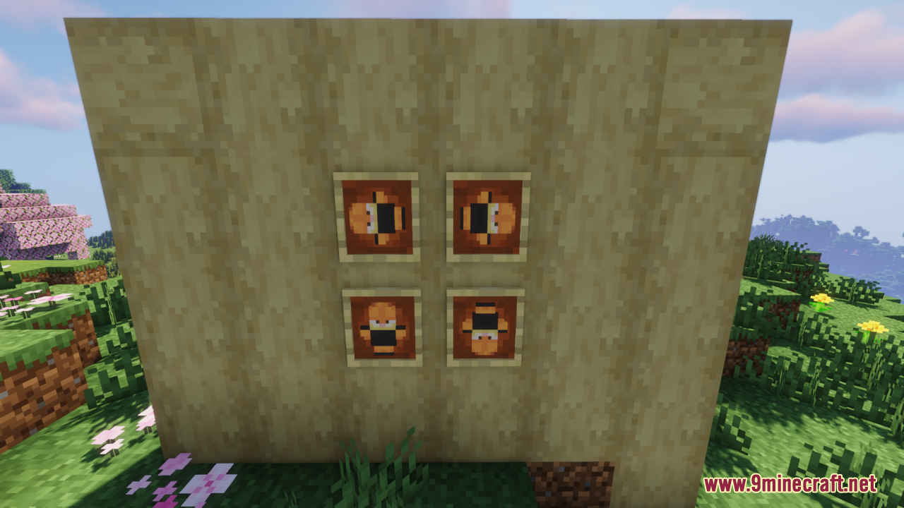 Four Garfield totems displayed in item frames on a wooden wall