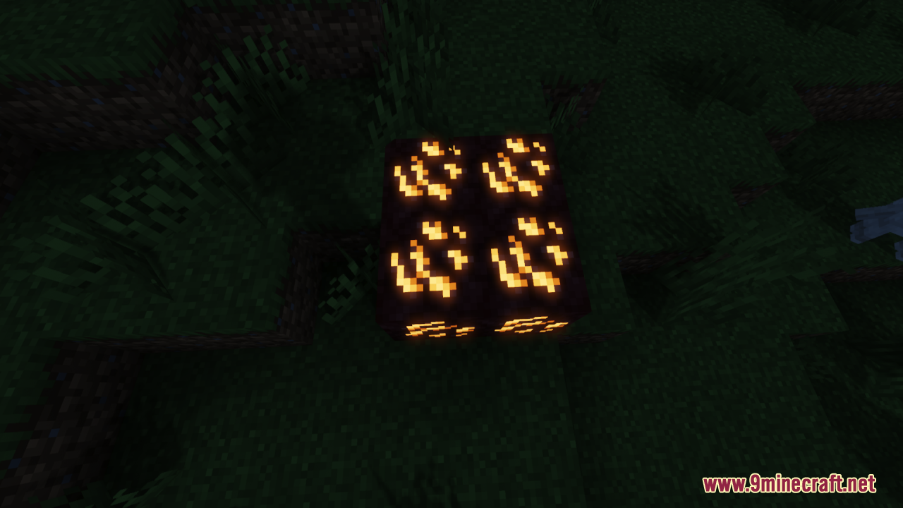 A cluster of four glowing orange ore blocks in a dark grassy area