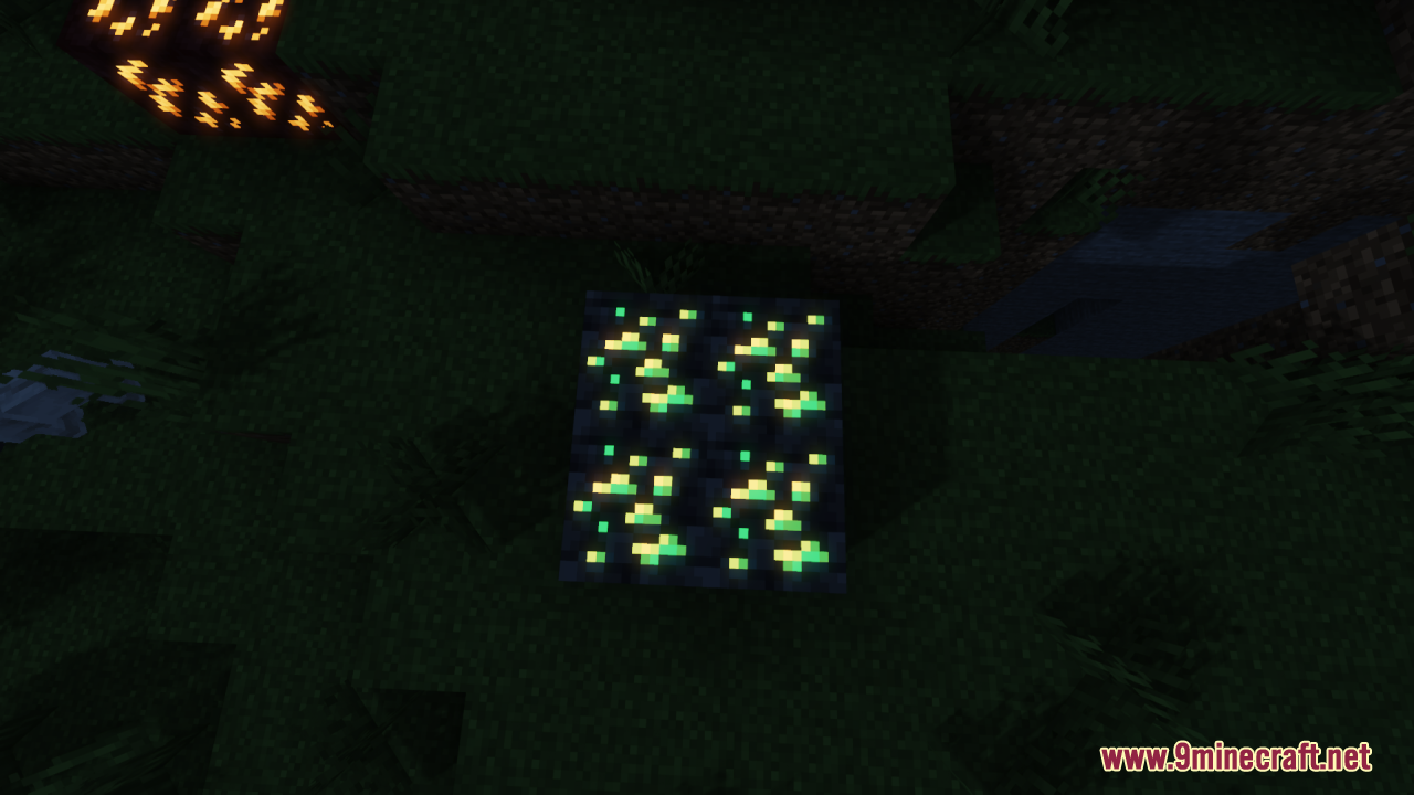 A cluster of four glowing green ore blocks in a dark grassy area