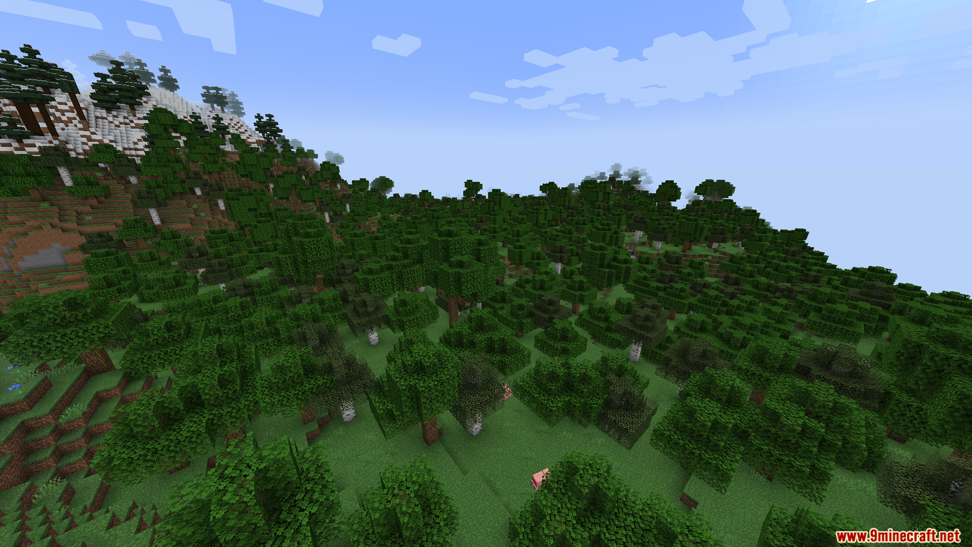 Gnetum Mod Screenshot 4 A wide landscape view of a dense forest biome and mountains