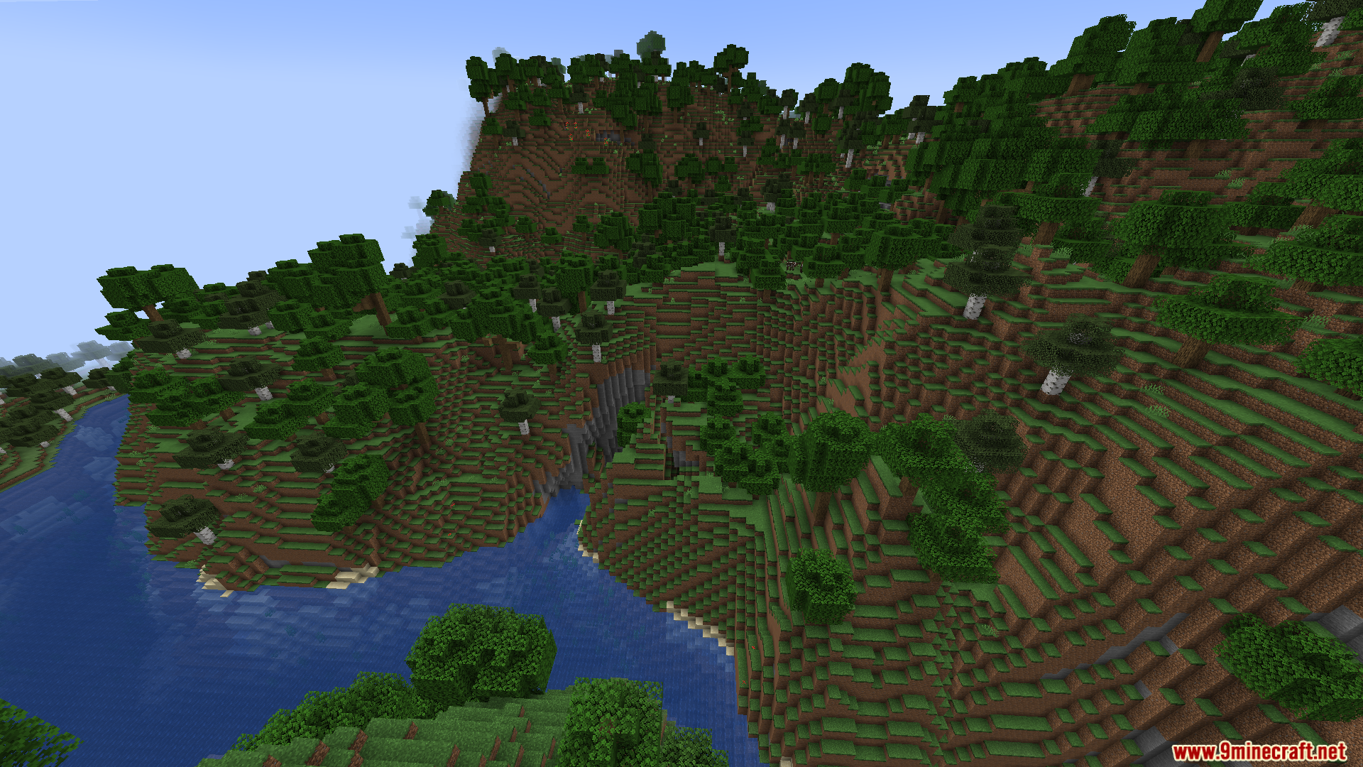 Gnetum Mod Screenshot 8 A blue river winding through a hilly forest with steep grassy cliffs
