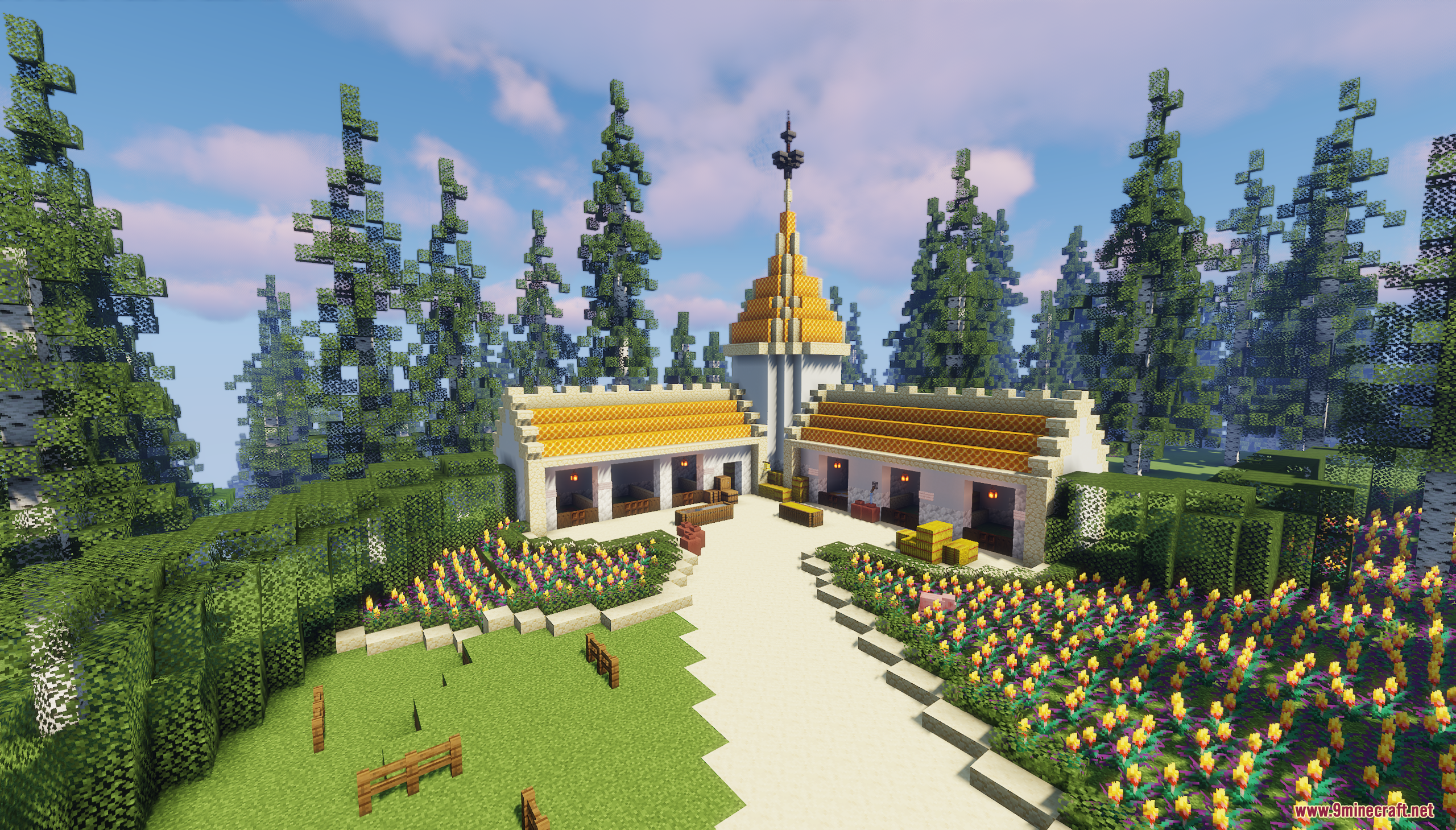 A scenic farm area featuring yellow roofed stables and vibrant flower gardens