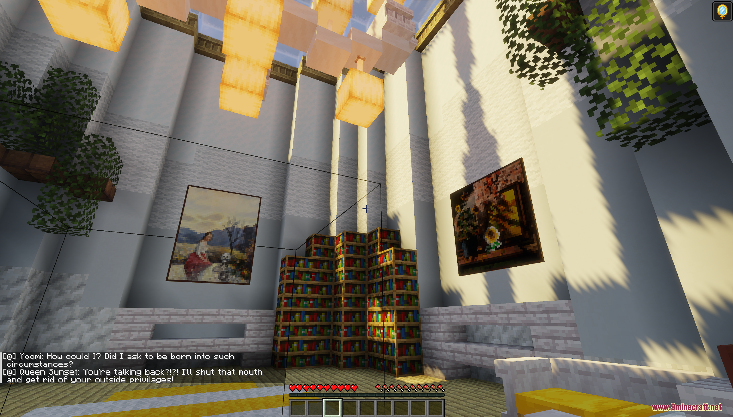 A tall library room with bookshelves and paintings under hanging glowstone lights