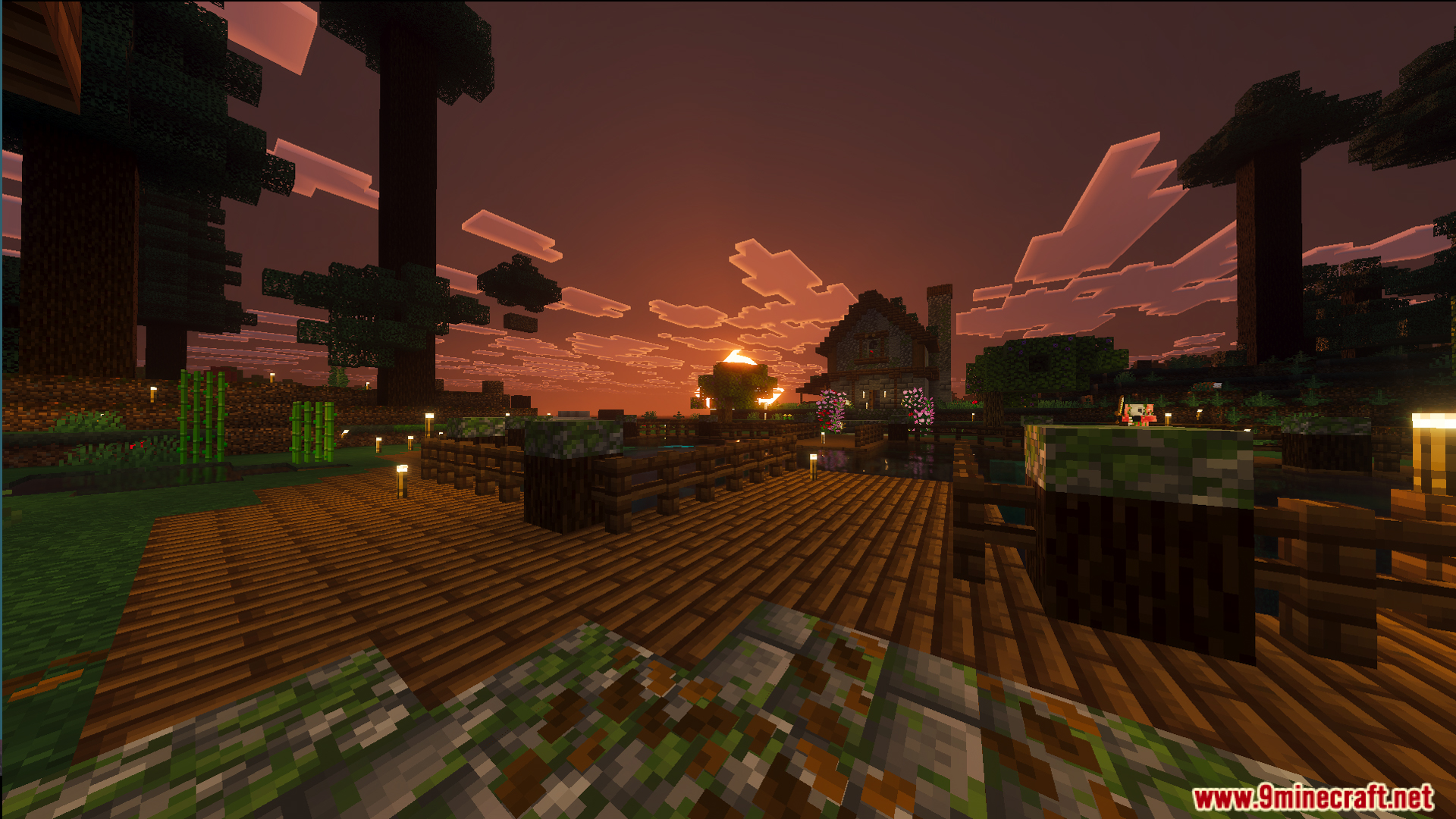 A beautiful lakeside base with a wooden deck and house at sunset