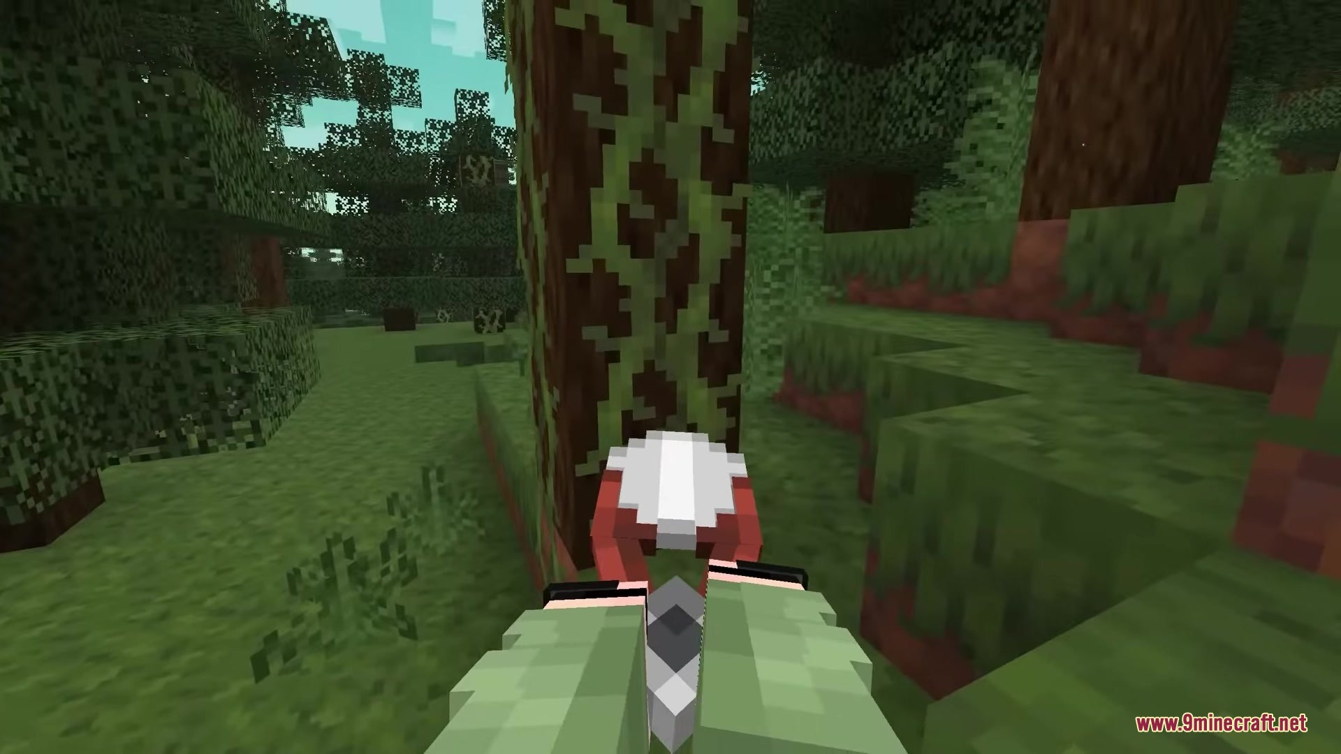 A player holding shears with custom hand poses near a tree with vines