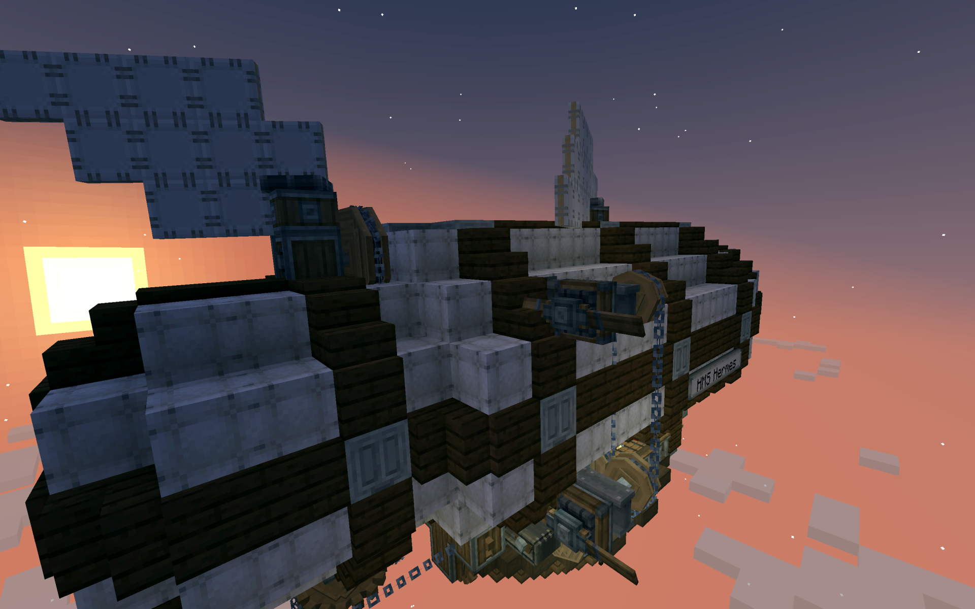 The HMS Hermes airship flying through the clouds during a vibrant sunset
