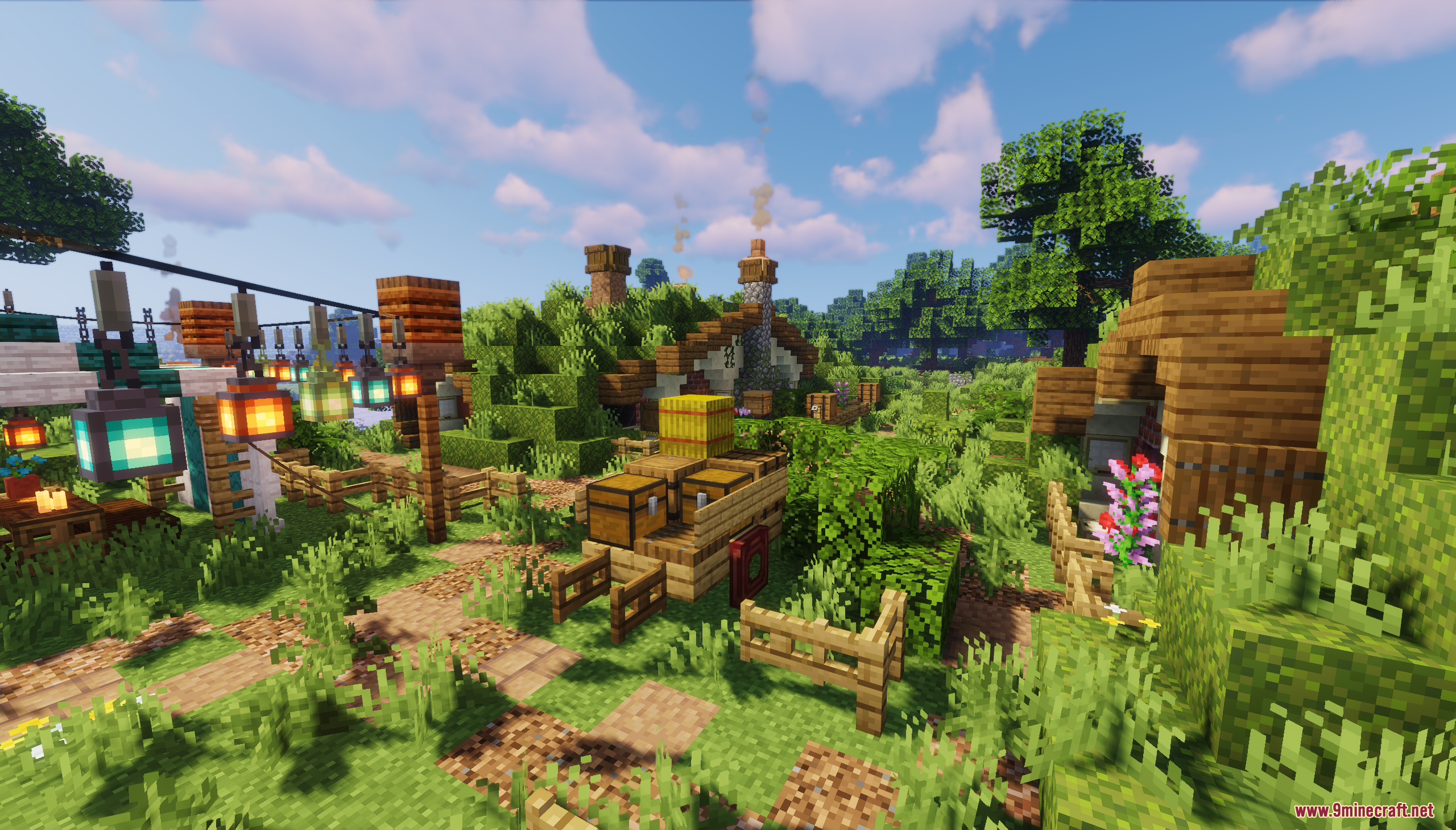 A wooden cart carrying chests and hay on a path near hobbit houses