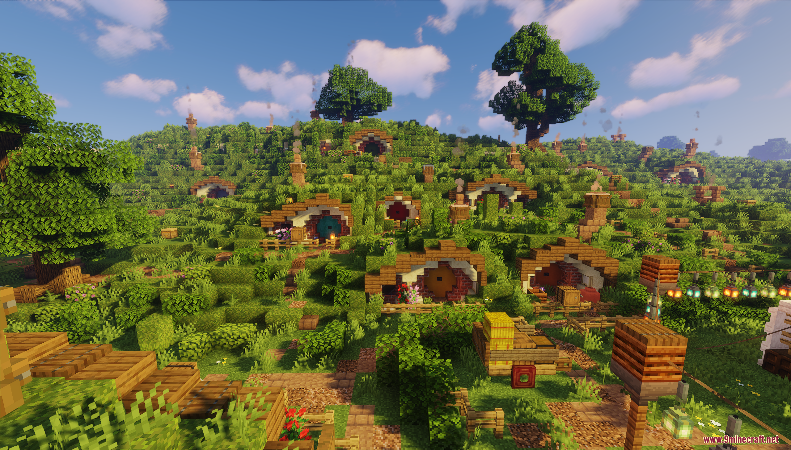 A vibrant Minecraft village featuring multiple hobbit holes on a sunny green hill