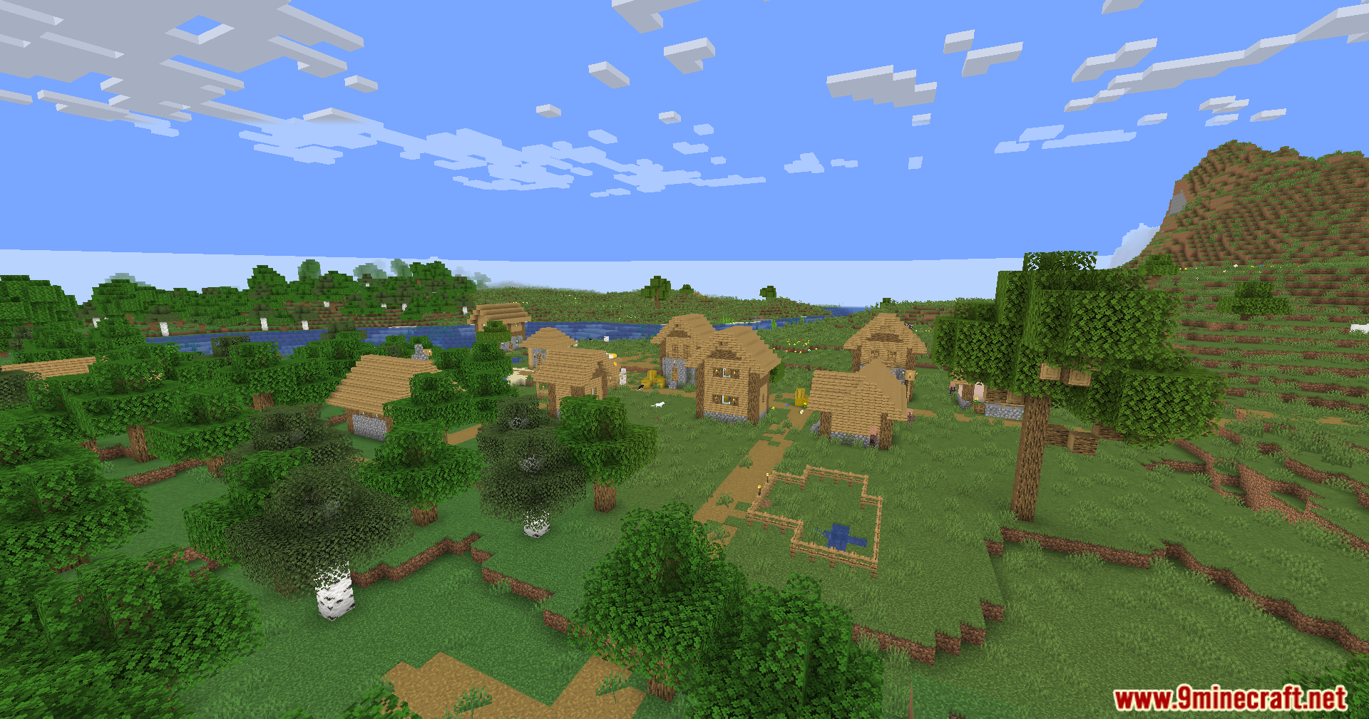 A scenic view of a Minecraft village with wooden houses and mountains