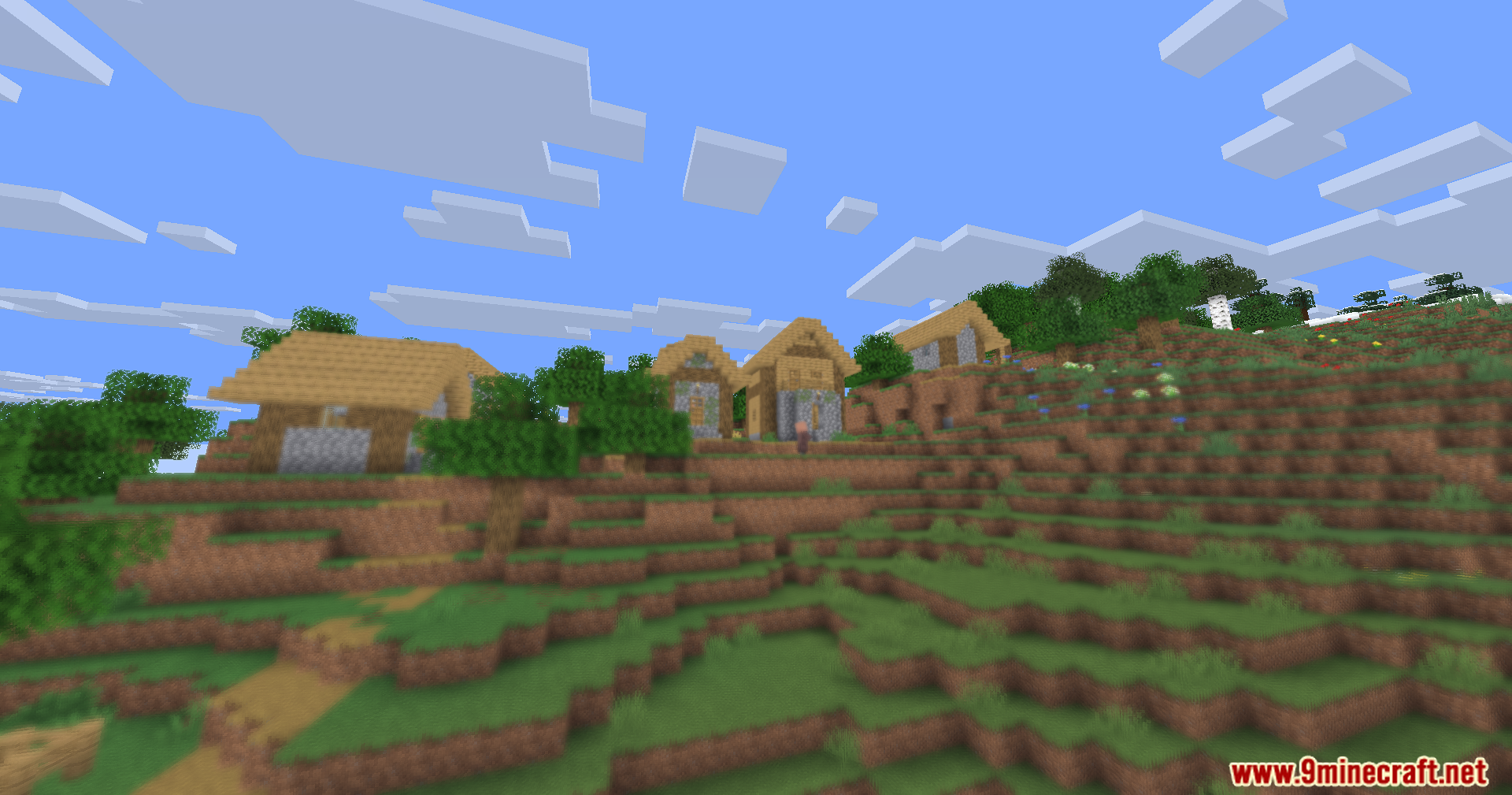 A hillside village with wooden houses and a soft blurry foreground area