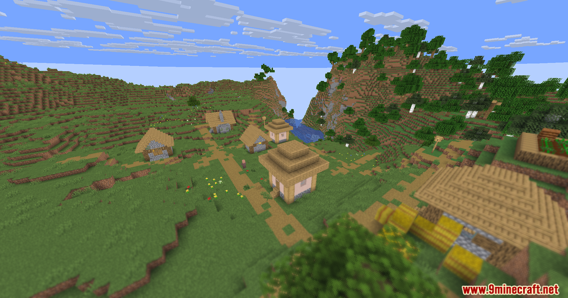 Sharp distant village buildings and mountains with a blurry foreground foliage effect