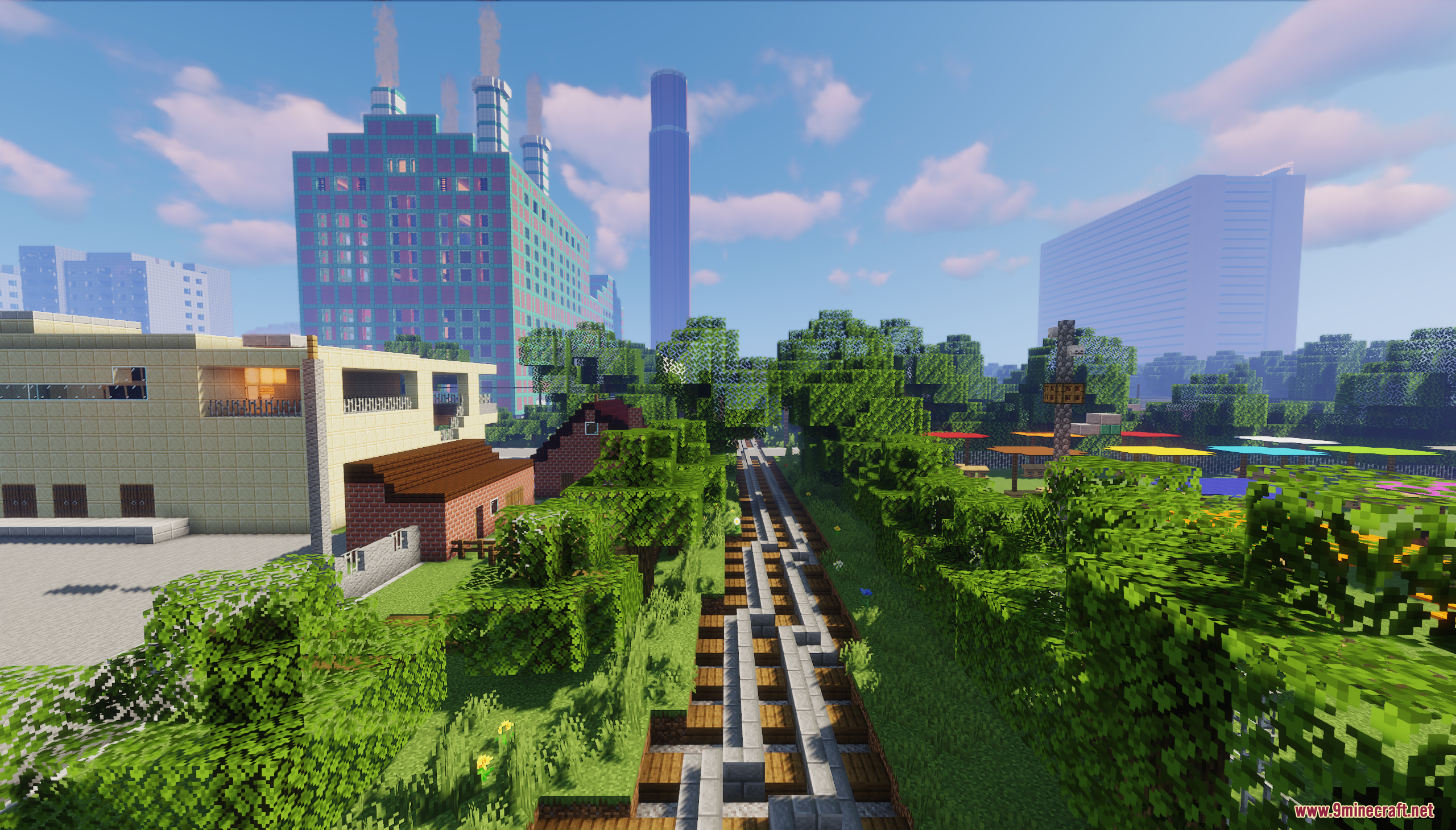 Railway tracks leading through a lush green area towards tall city buildings