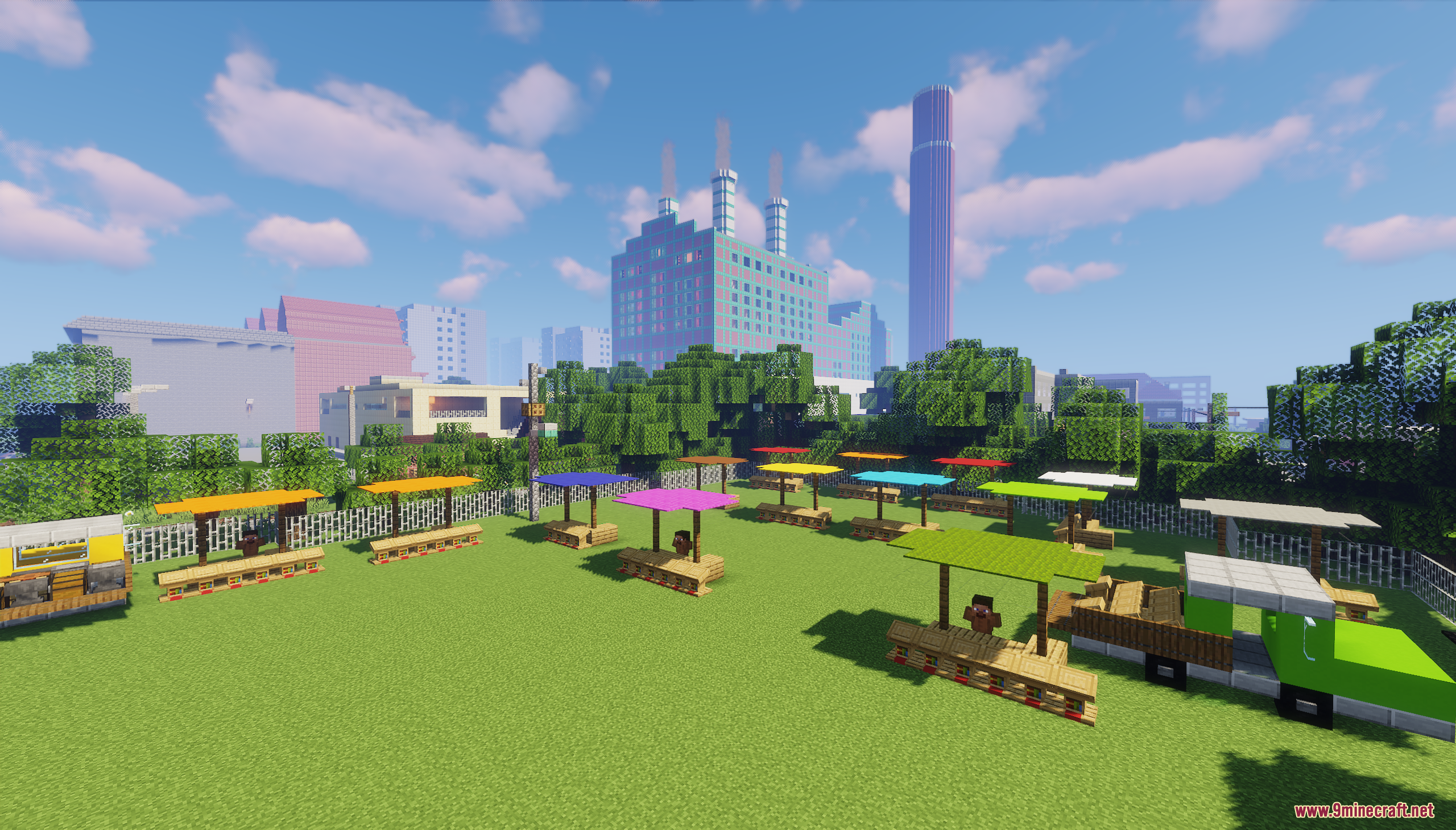 Colorful market stalls on a grassy field with a city skyline behind