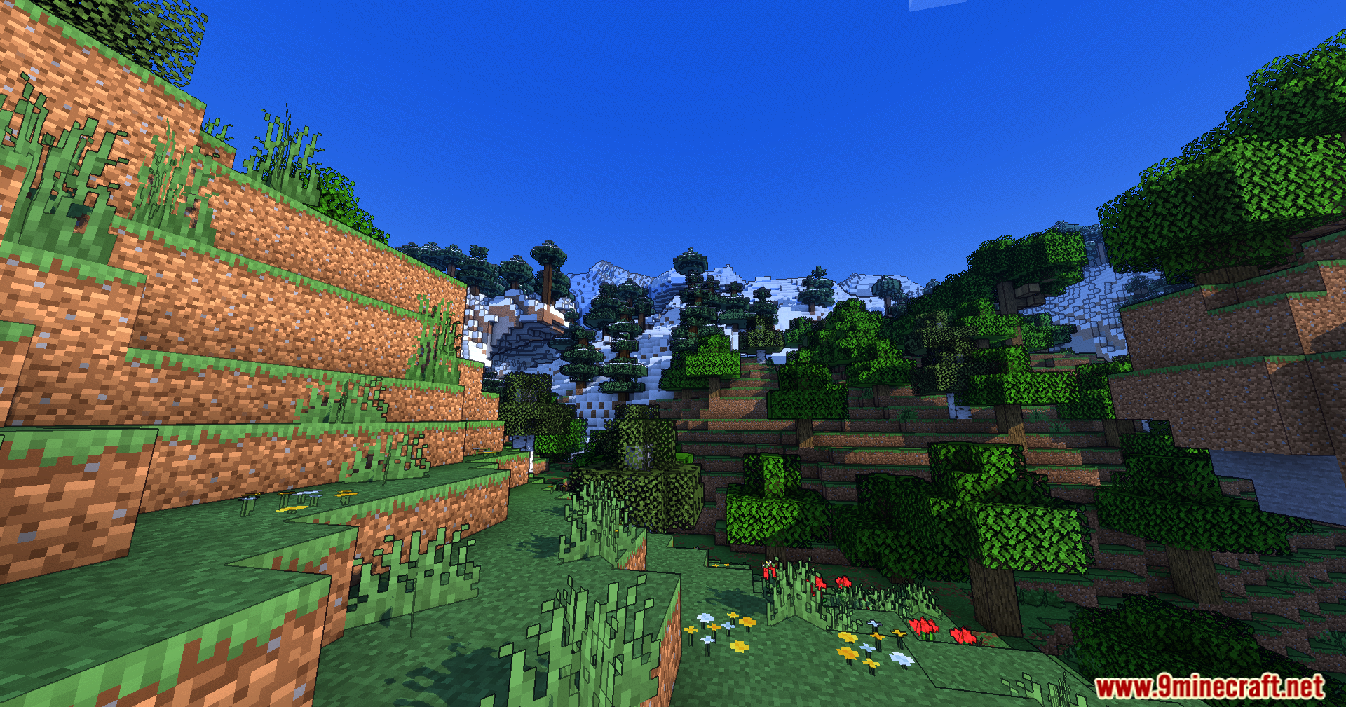 Vibrant valley with cartoon style shaders and distant snowy mountain peaks