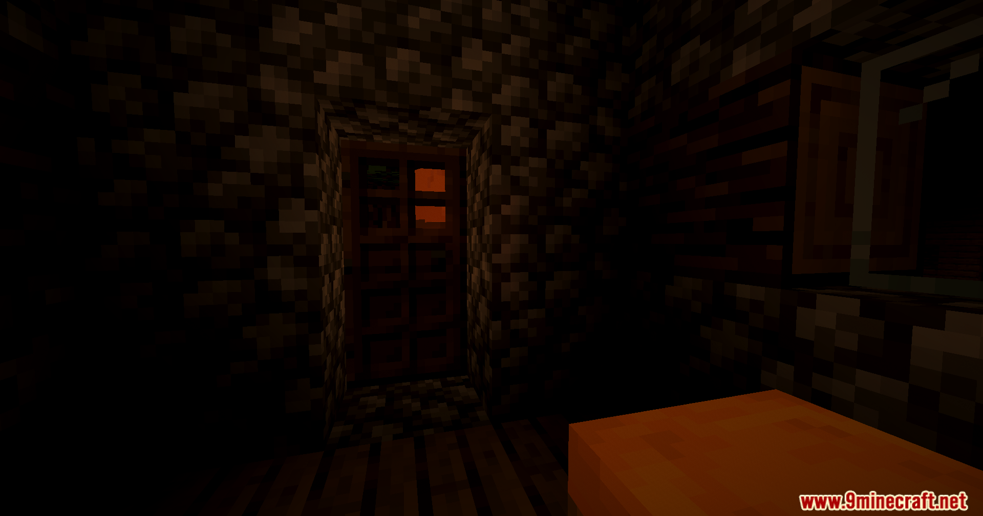 Looking at a wooden door from inside a dark cobblestone house at night