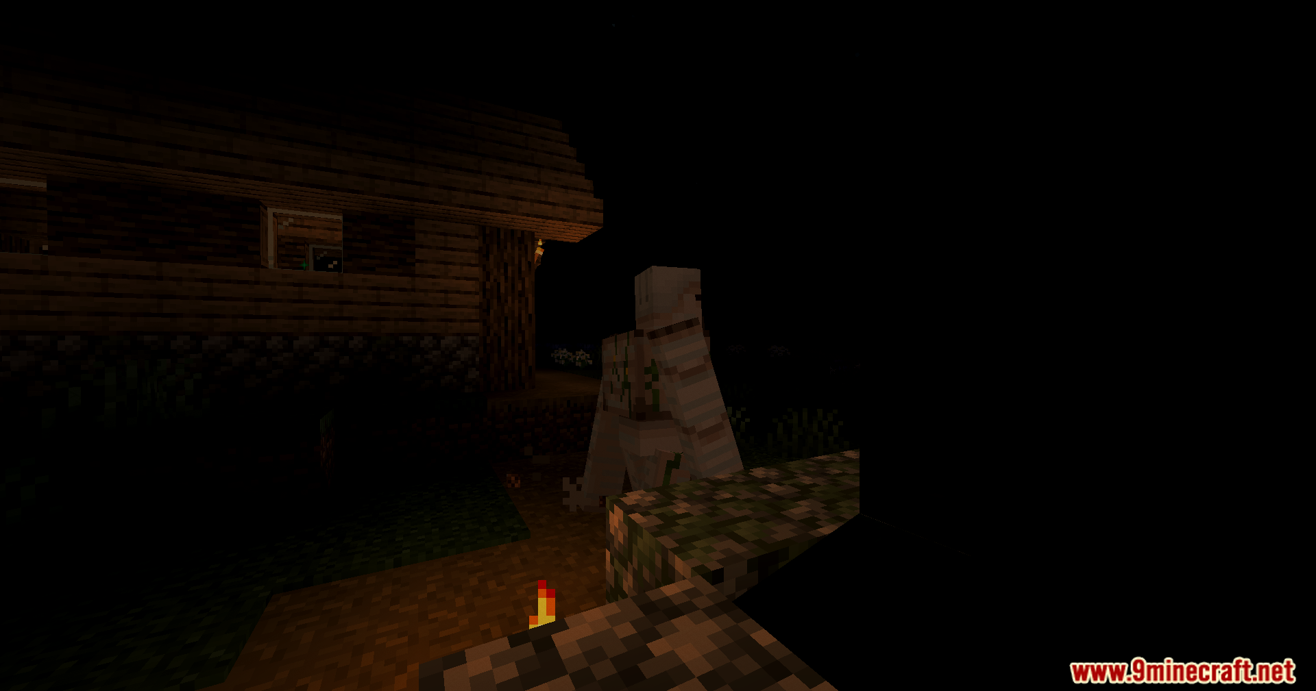 An Iron Golem stands near a house under the Karma Shader Nightmare Shaders