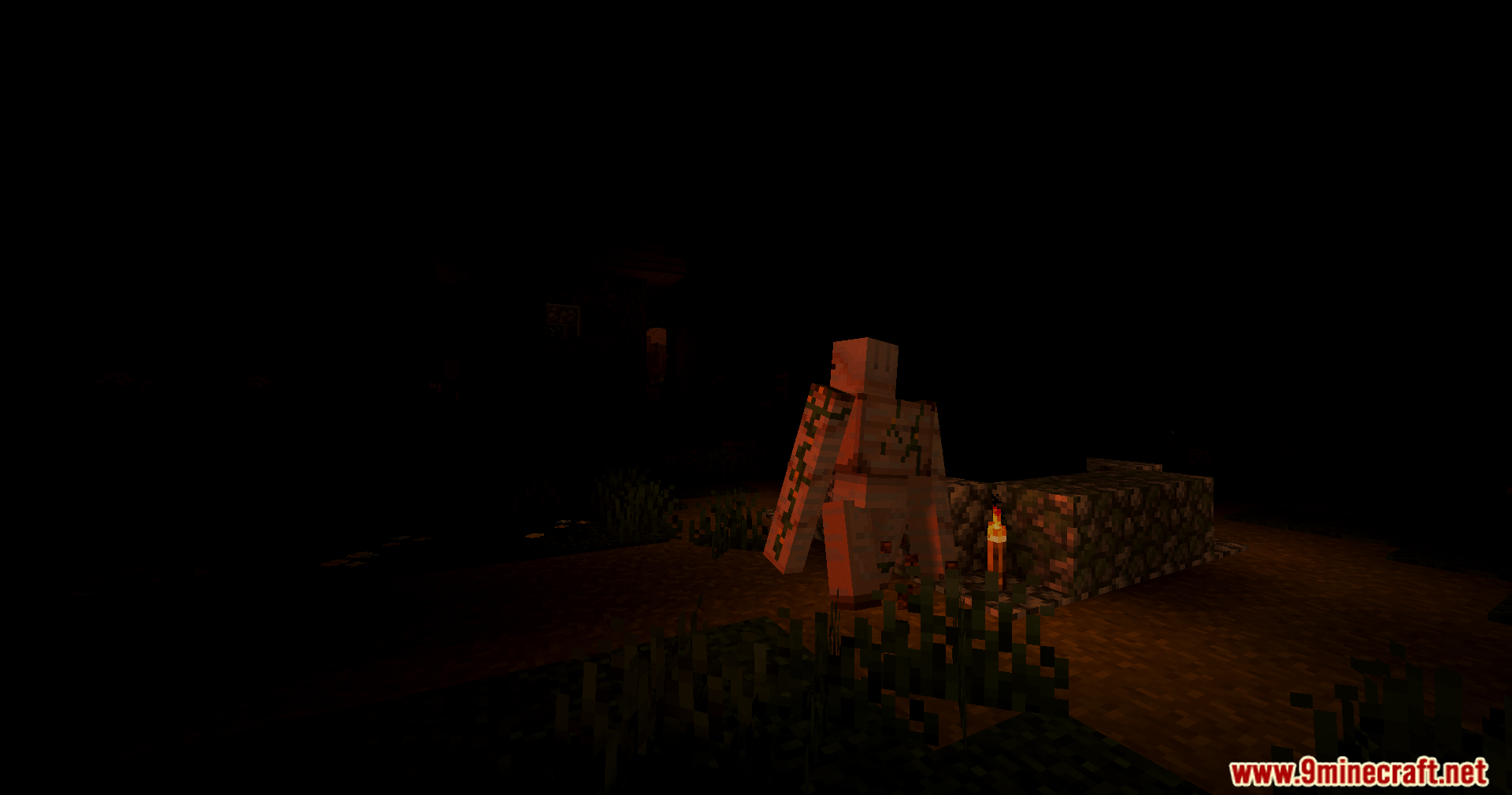 A damaged iron golem stands in a dark forest lit by a torch