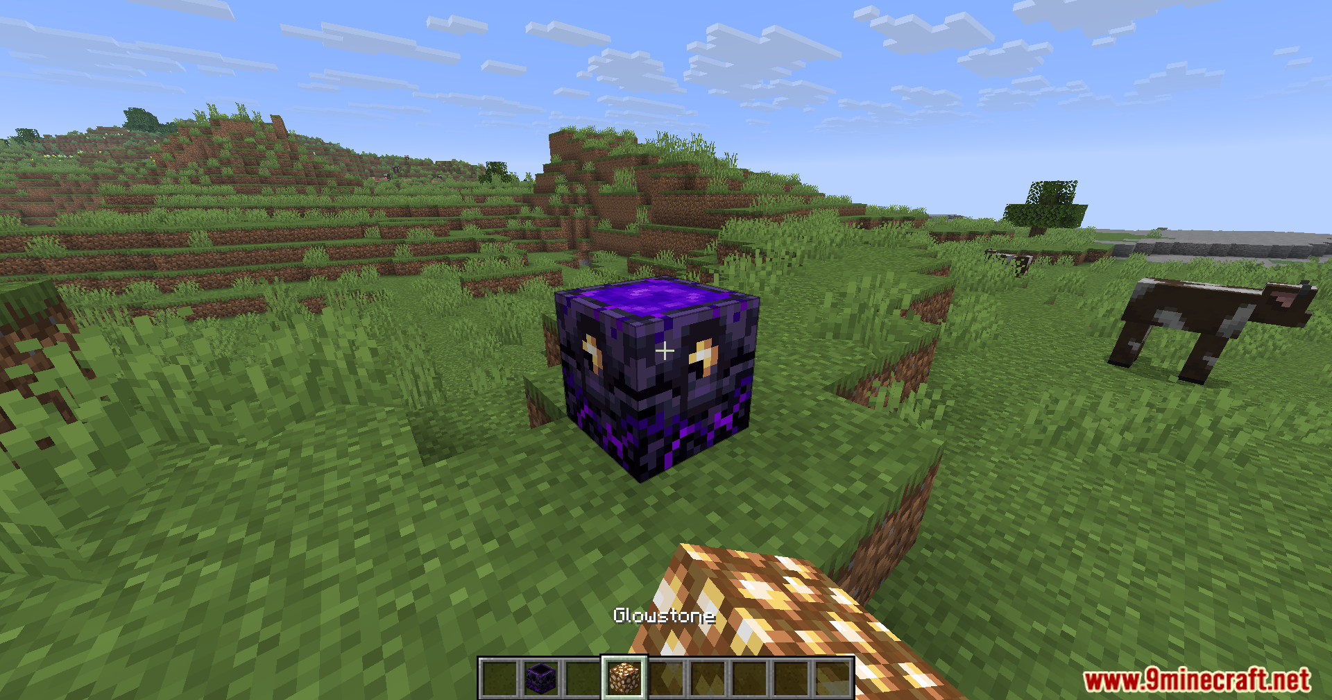 A player adds a glowstone charge to a respawn anchor in the plains