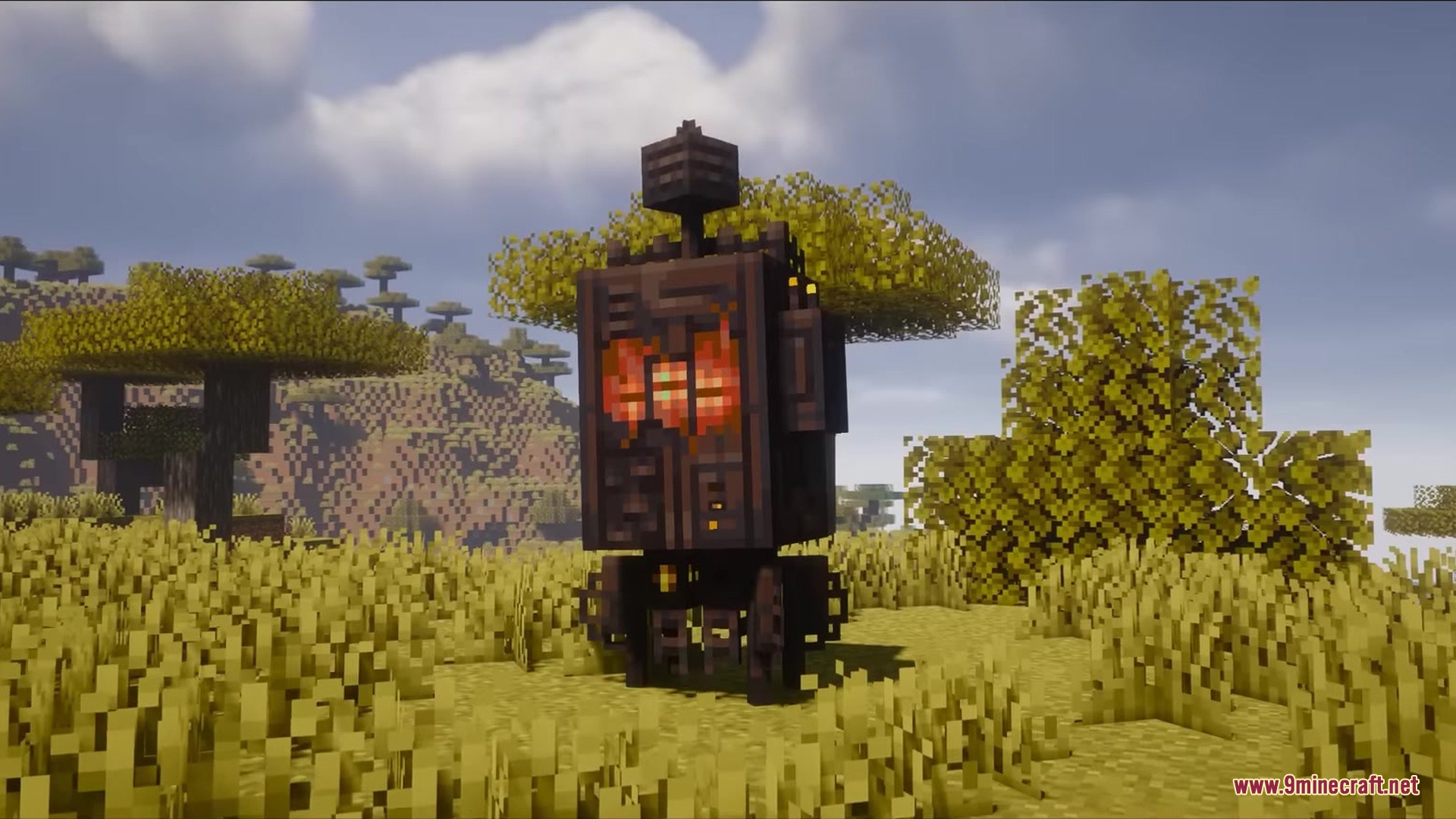 A large bulky robot with a glowing face stands in a savanna