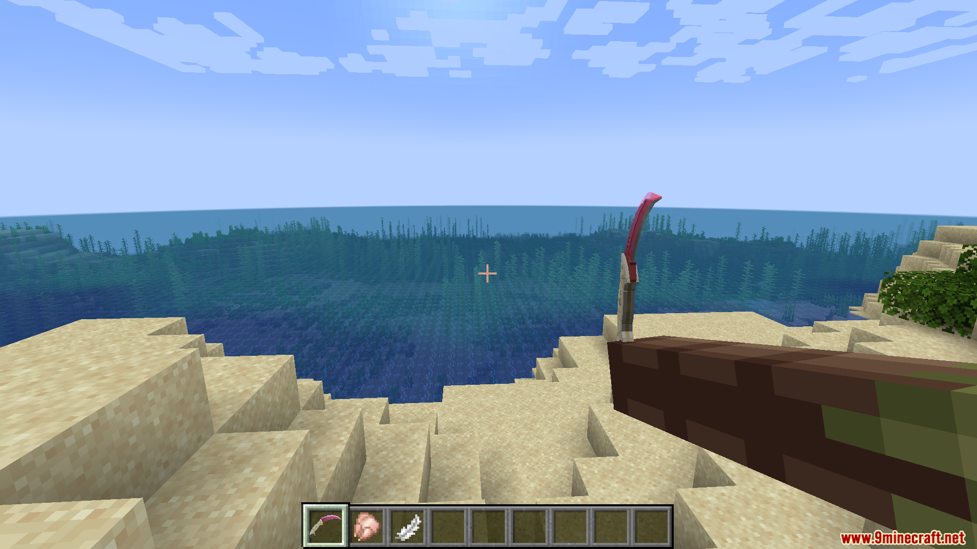 A player holds a pink karambit knife while standing on a sandy beach