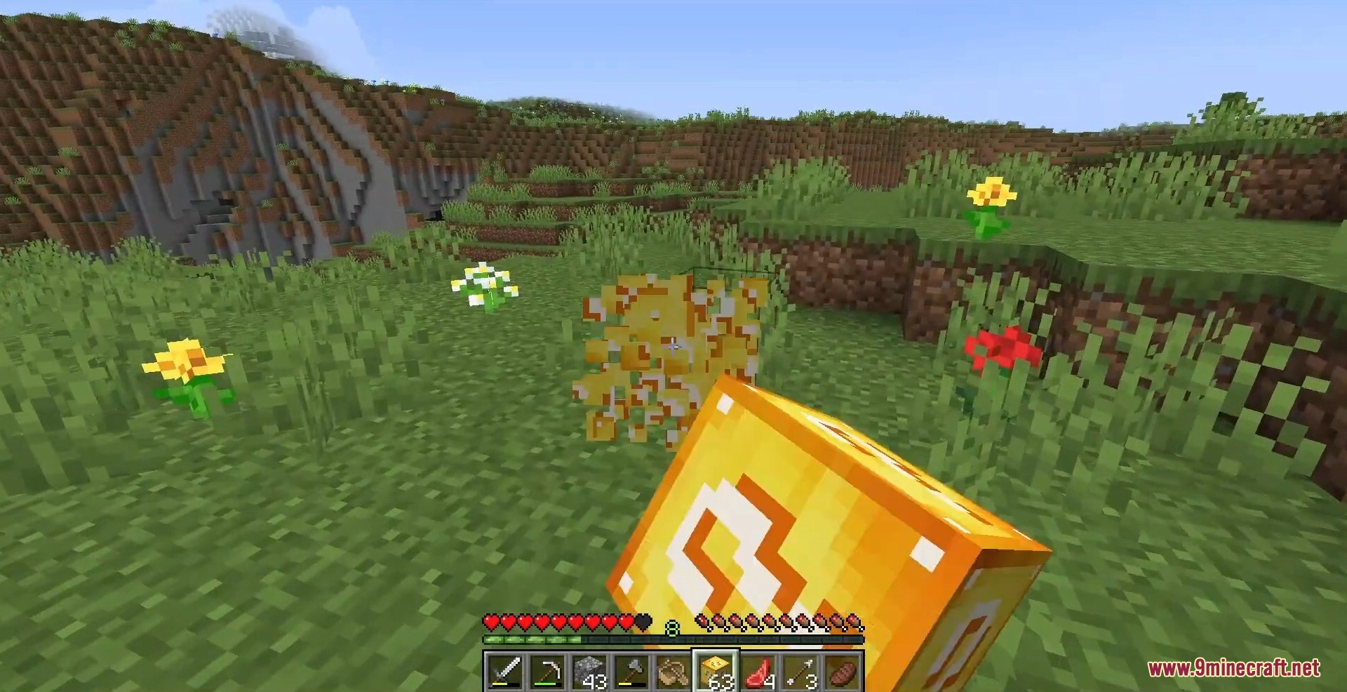 Breaking a golden block releases bright yellow particles on a grassy field