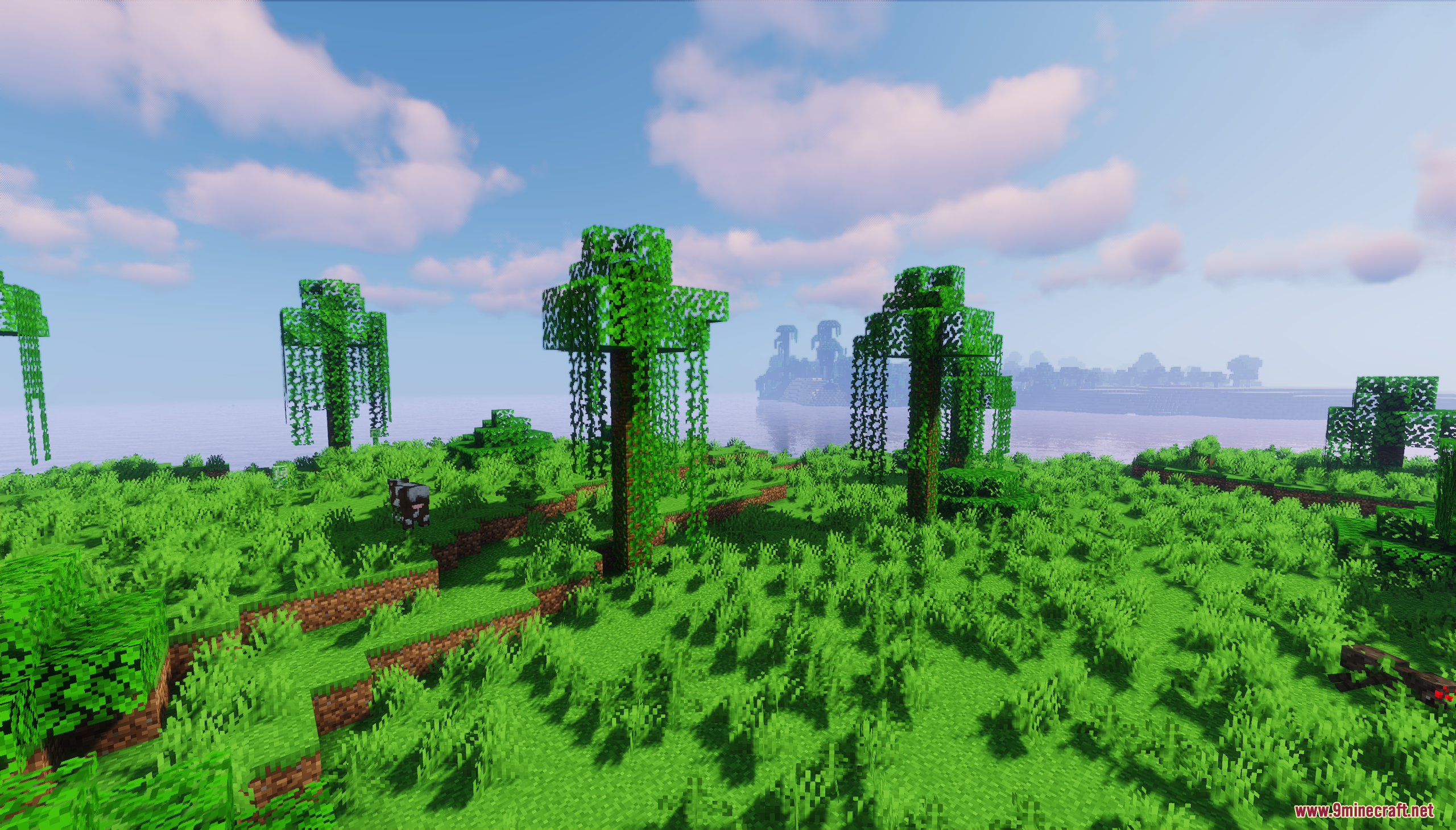 Luz Island Map Screenshot 10 A cow grazes in a grassy field with custom trees near the blue ocean