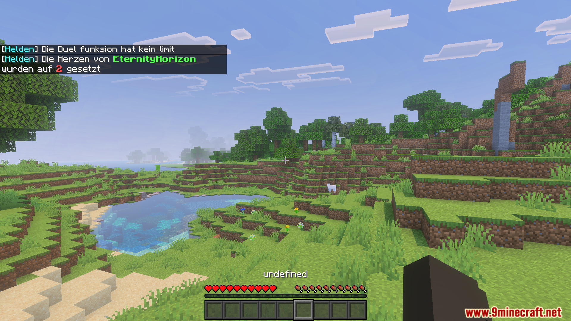 M Helden Addon Screenshot 5 Chat notifications about heart settings and duels shown over a Minecraft landscape