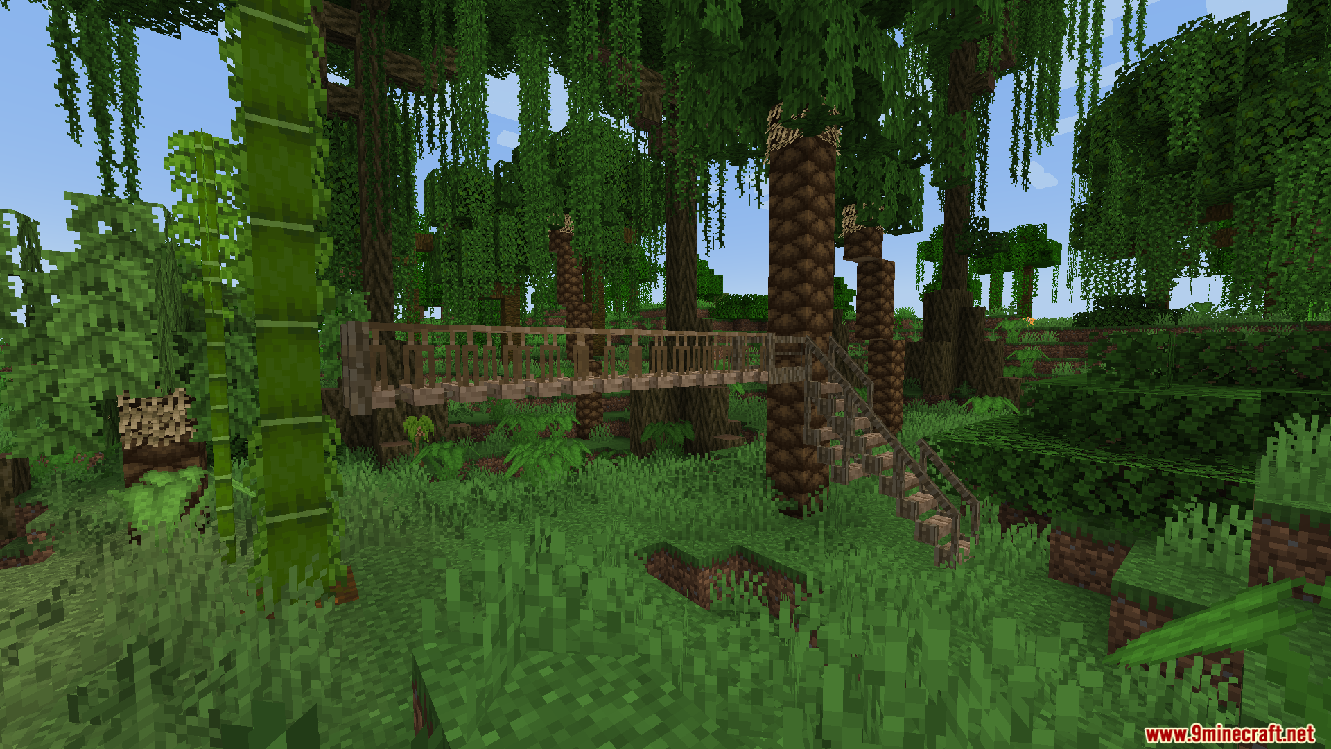 Macaws Regions Unexplored Mod Screenshot 5 A wooden bridge with stairs connecting a large jungle tree to the ground